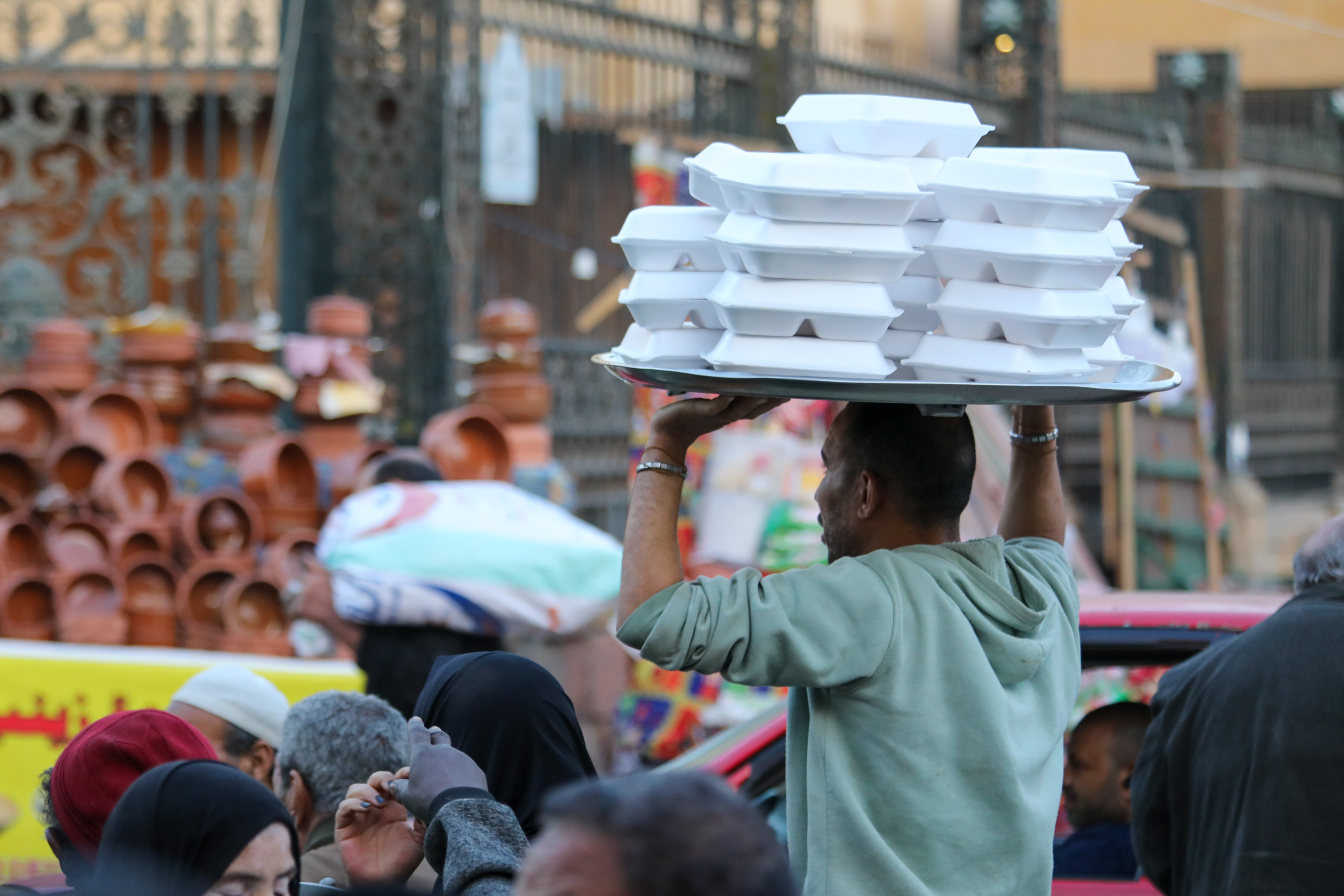 A man carries boxes of food on his head