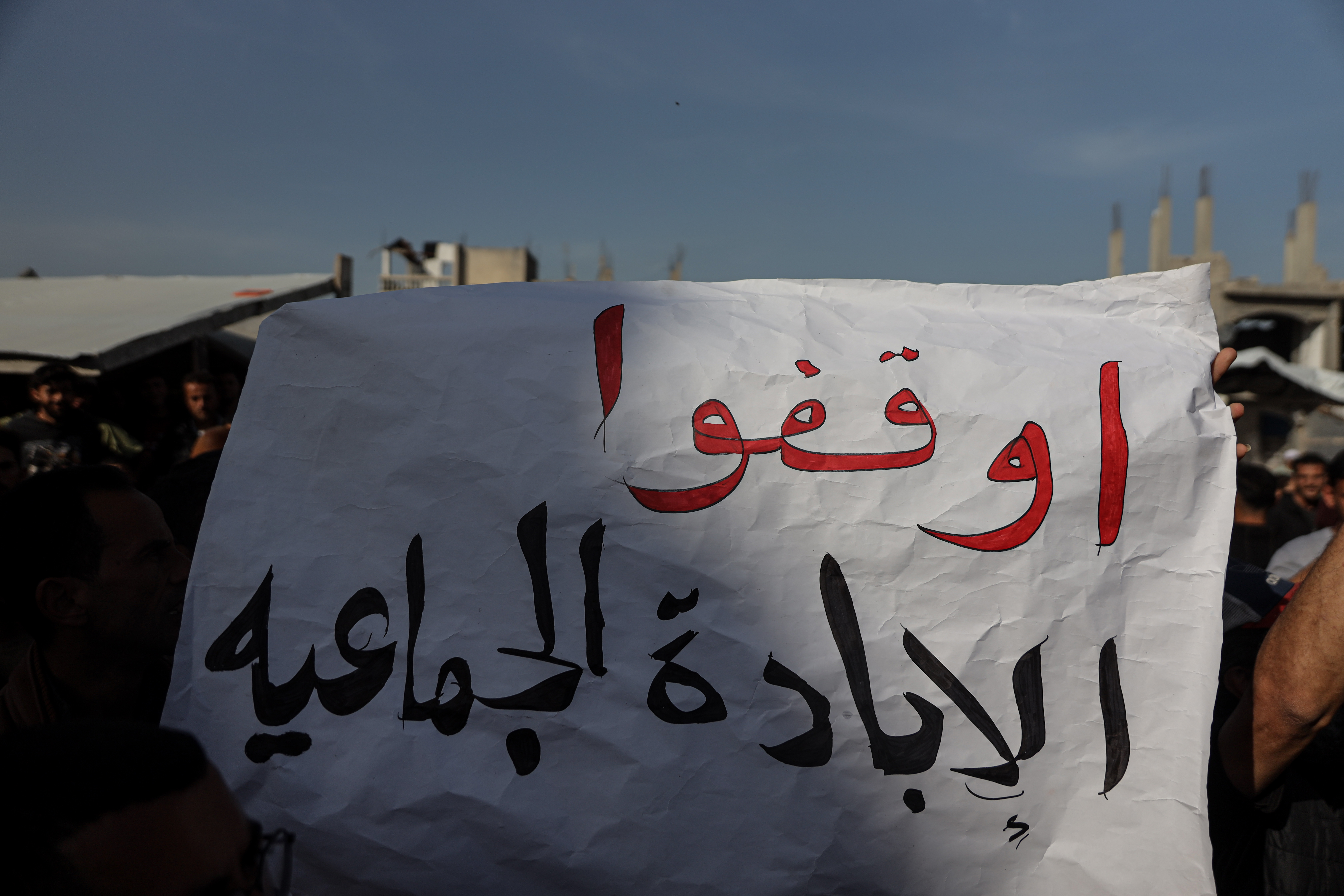 A sign that reads 'STOP the genocide'