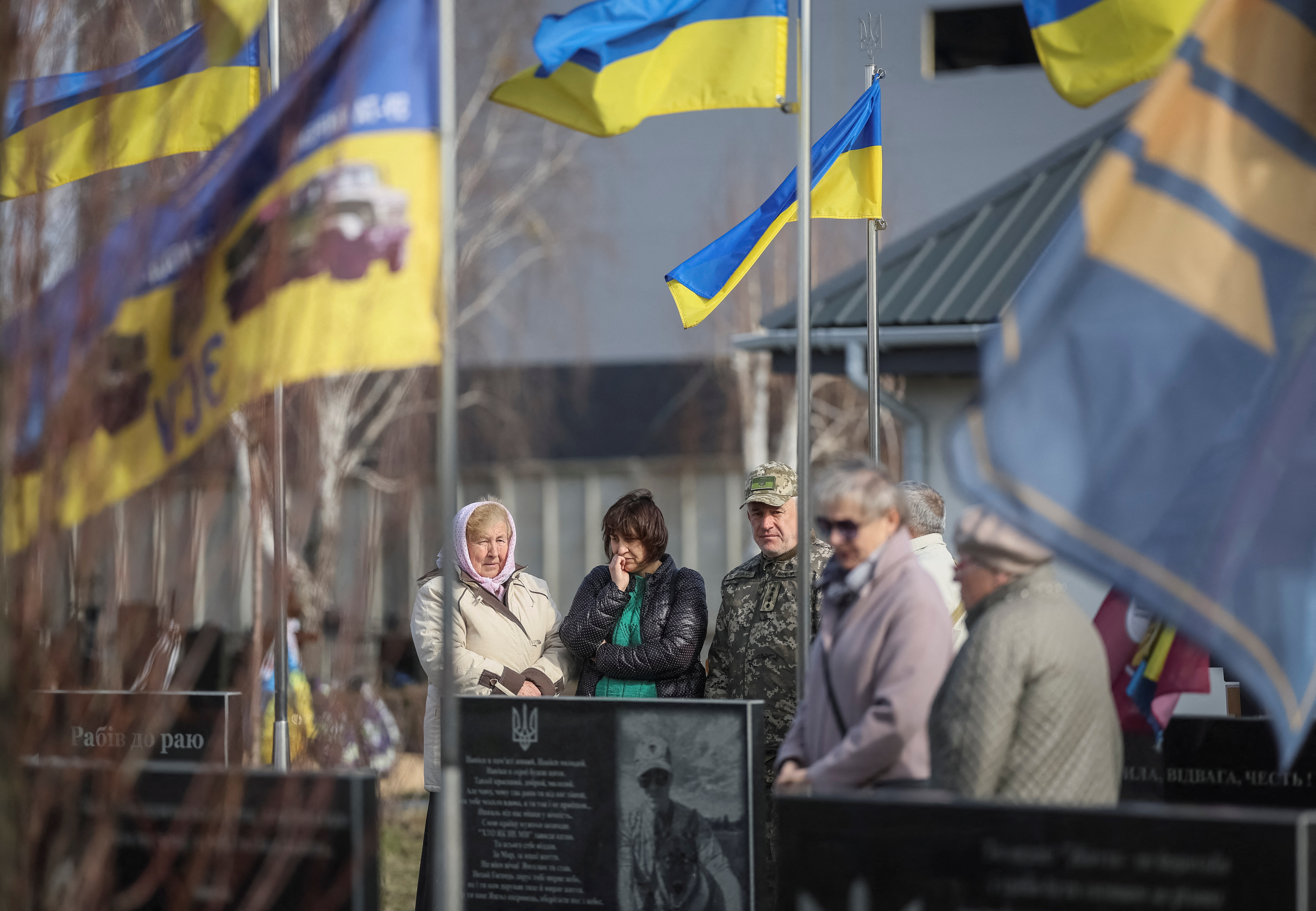 Ukrainians visit the graves of relatives.