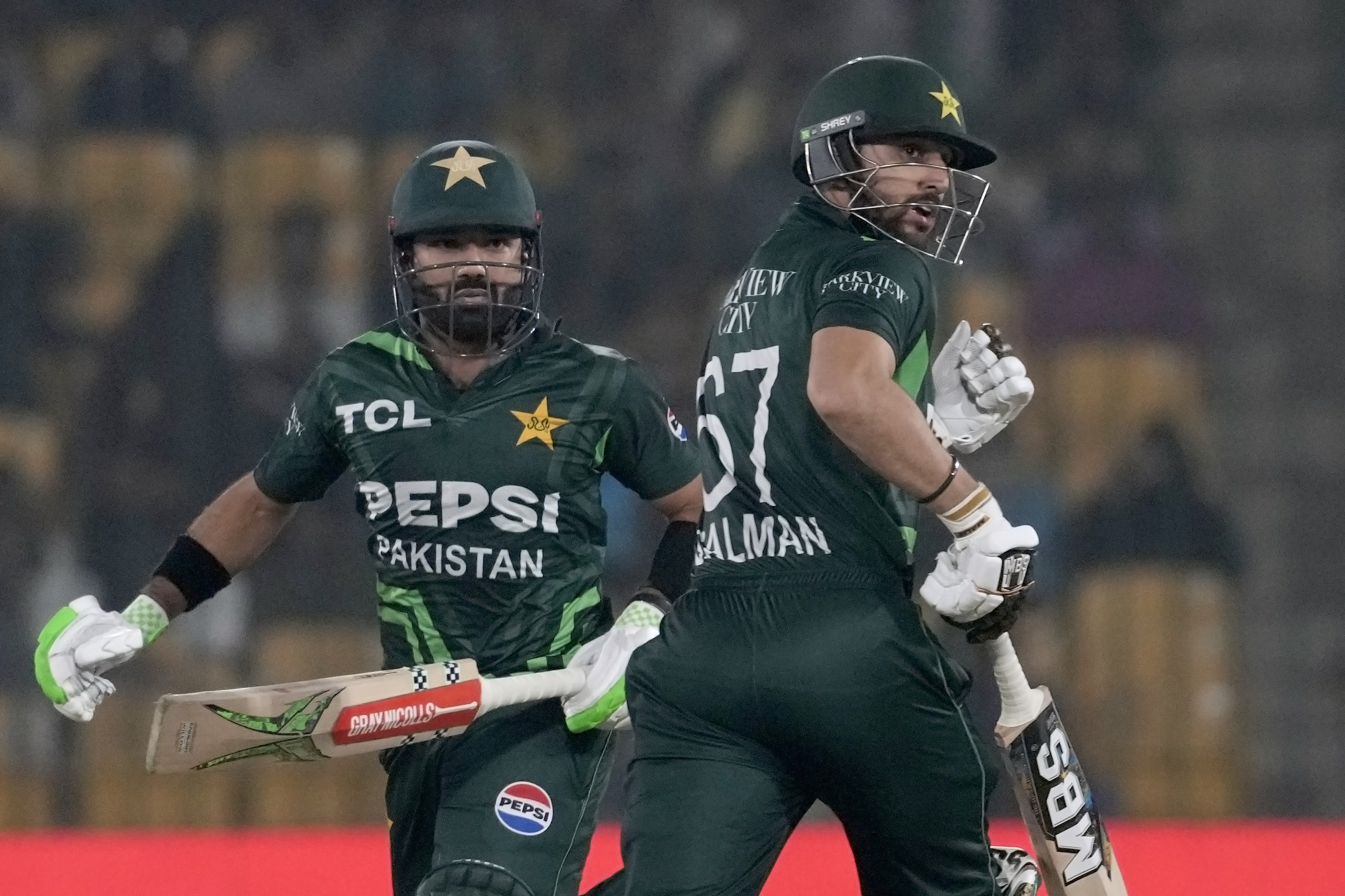 Pakistan's Mohammad Rizwan, left, Salman Ali Agha run between the wickets during the tri-series ODI cricket match between Pakistan and South Africa, in Karachi, Pakistan, Wednesday, Feb. 12, 2025. (AP Photo/Fareed Khan)
