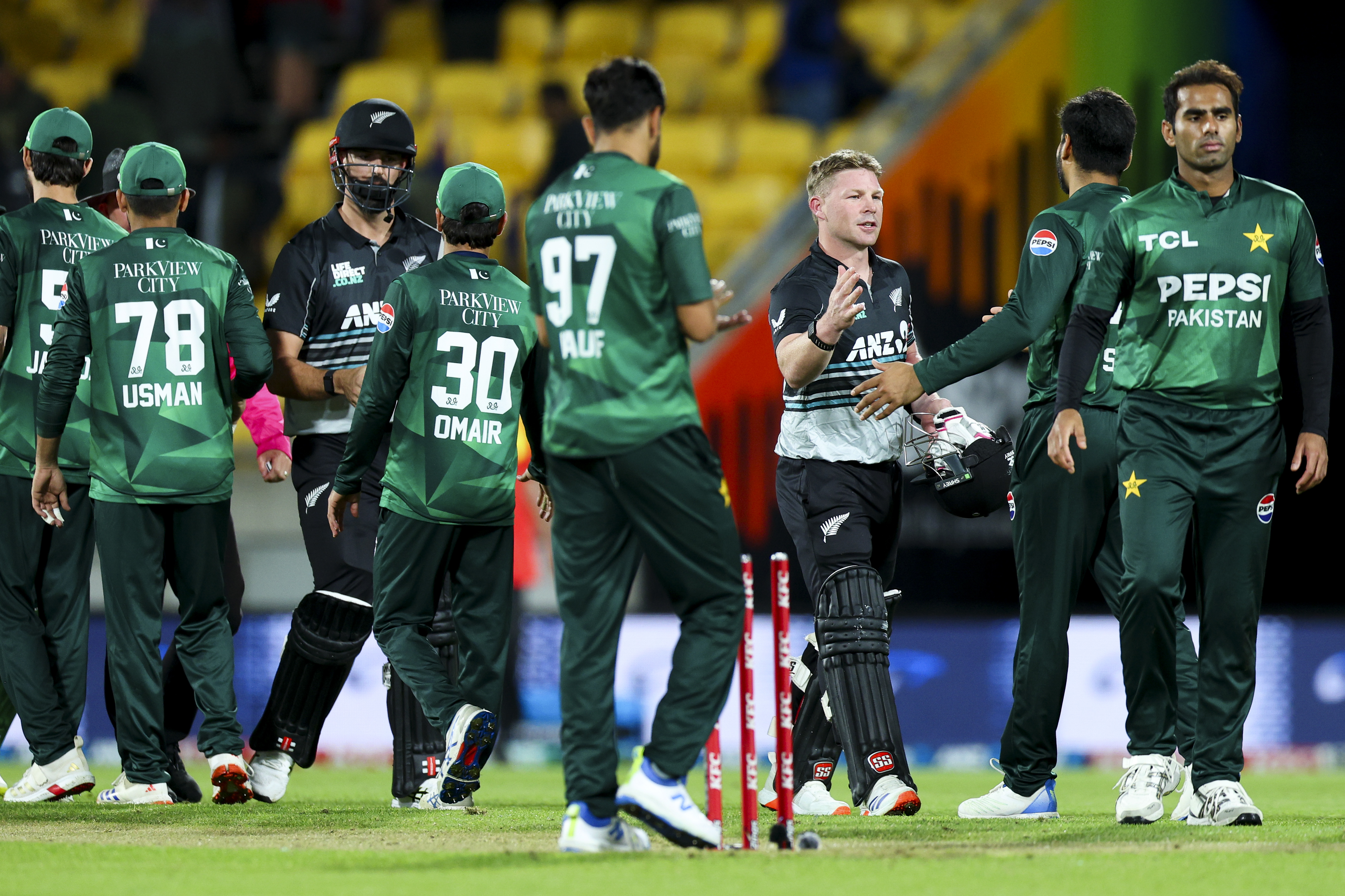 WELLINGTON, NEW ZEALAND - MARCH 26: Tim Seifert and Daryl Mitchell of New Zealand shake hands with Pakistan players after winning game five of the Men's T20 series between New Zealand and Pakistan at Sky Stadium, on March 26, 2025, in Wellington, New Zealand. (Photo by Hagen Hopkins/Getty Images)