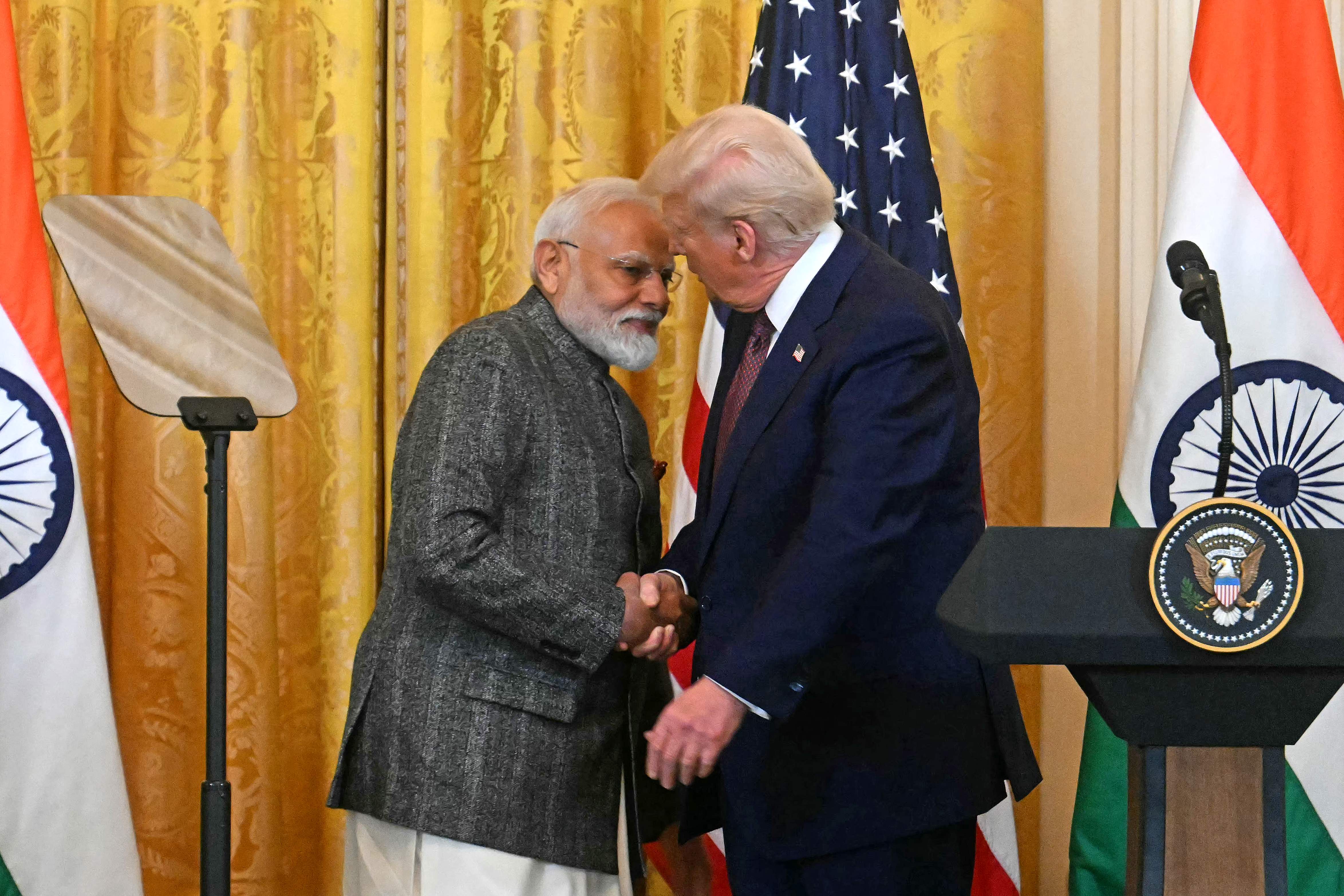 US President Donald Trump shakes hands with Indian Prime Minister Narendra Modi.