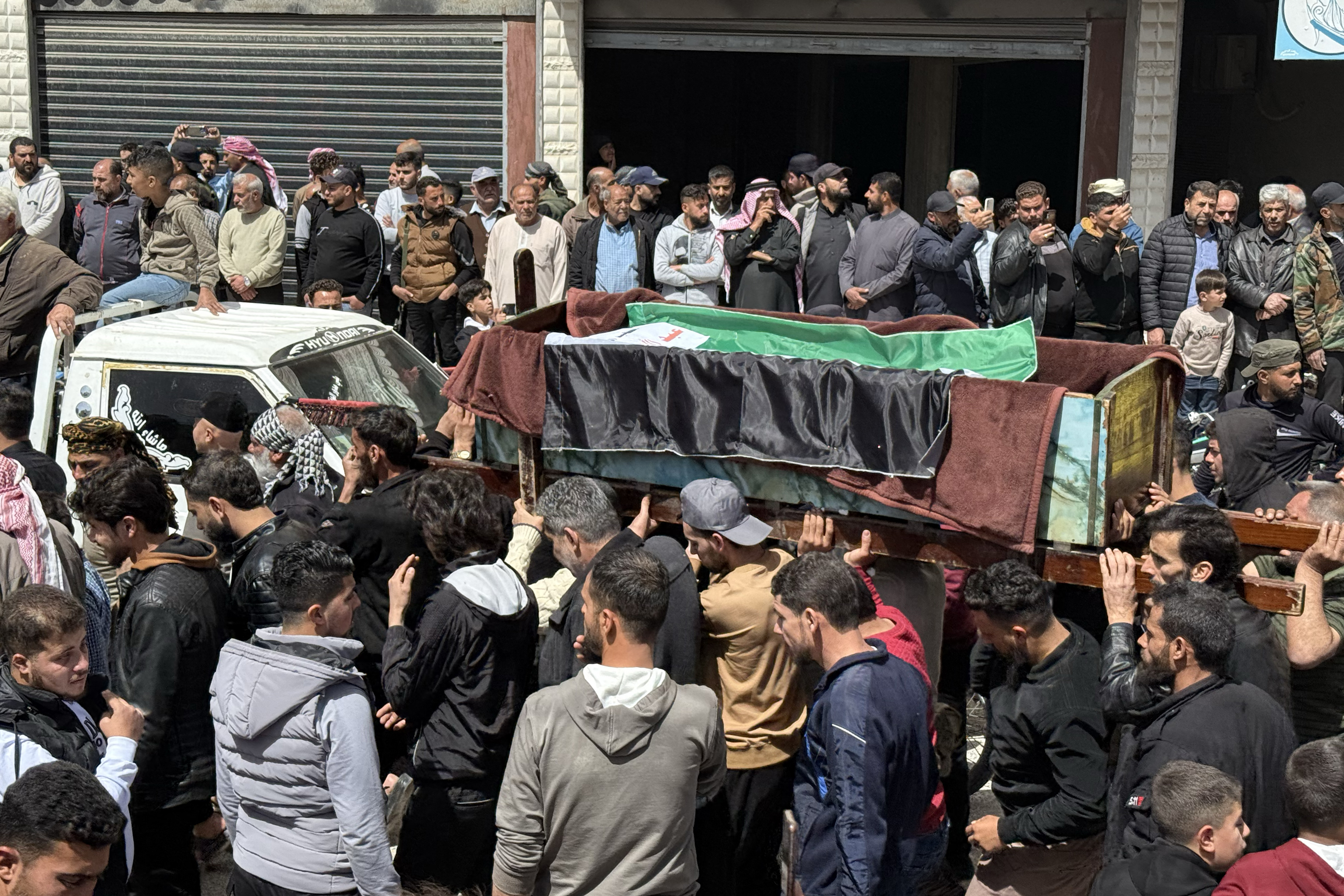 Funeral of victims killed in Israeli shelling of Nawa in Syria.
