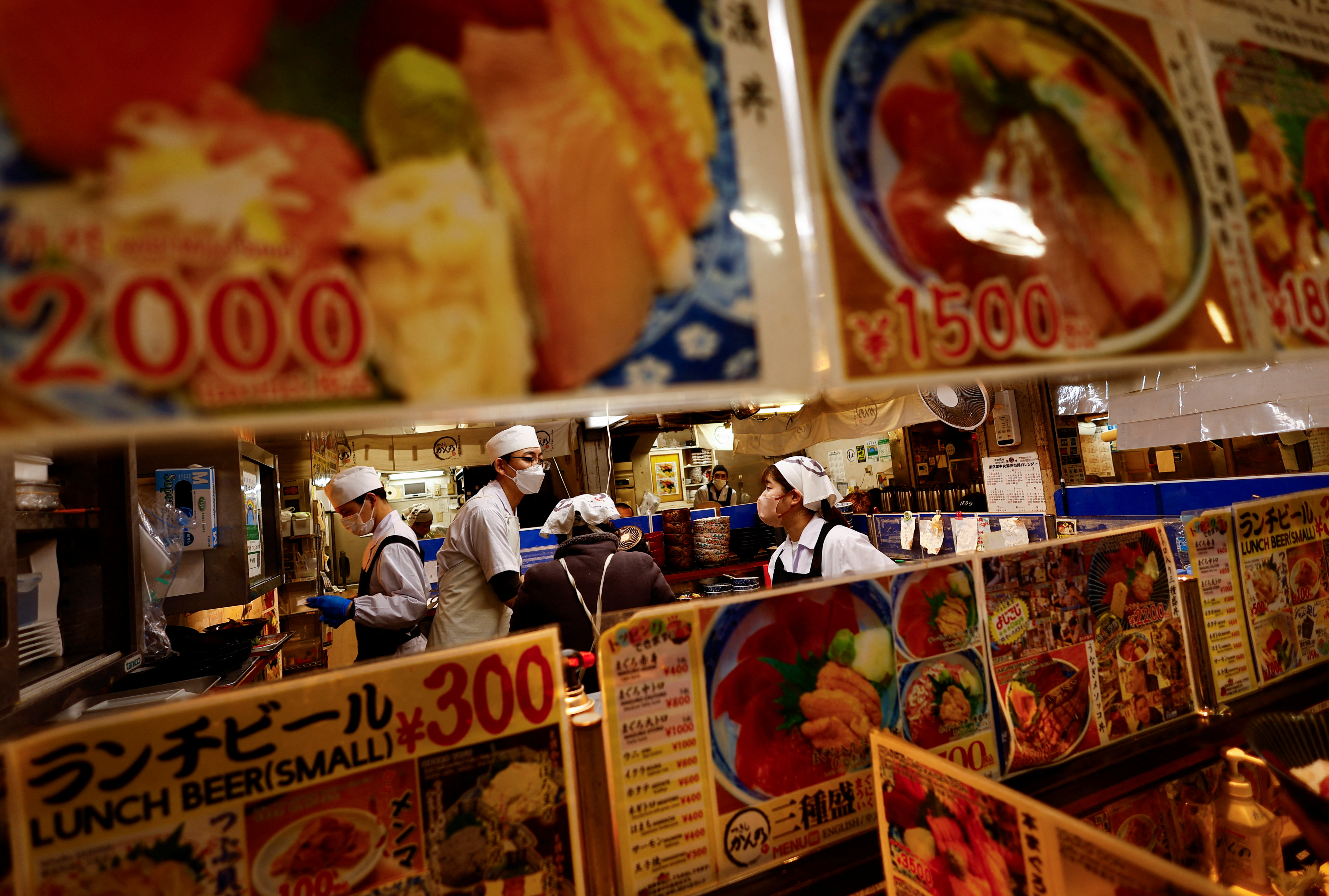 Employees of a seafood restaurant work in their kitchen space at Tsukiji Outer Market in Tokyo, Japan, February 15, 2024. REUTERS/Issei Kato