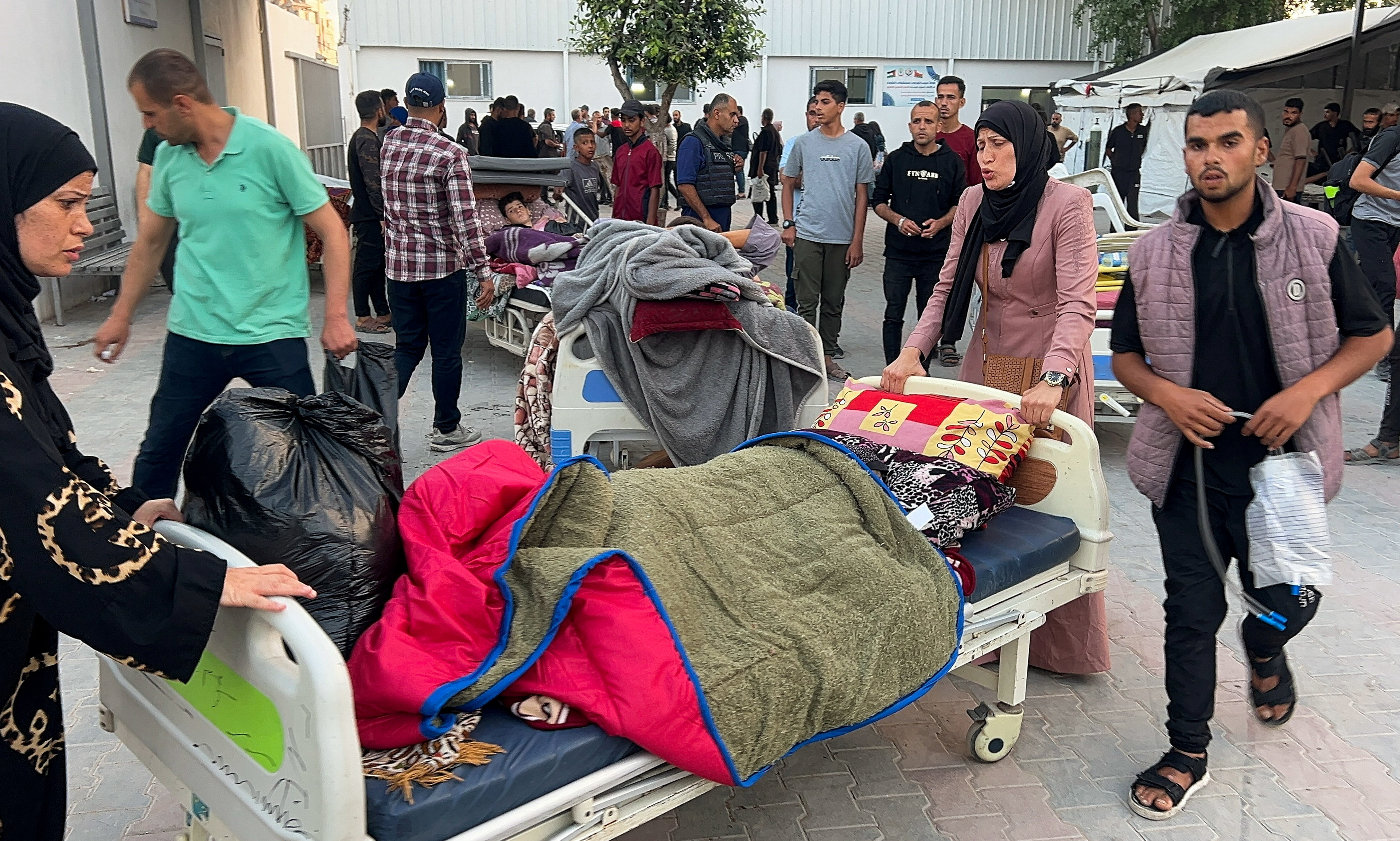 Palestinian patients flee Al-Shifa Hospital after the Israeli army ordered its evacuation, in Gaza City, May 14, 2025. [Reuters]