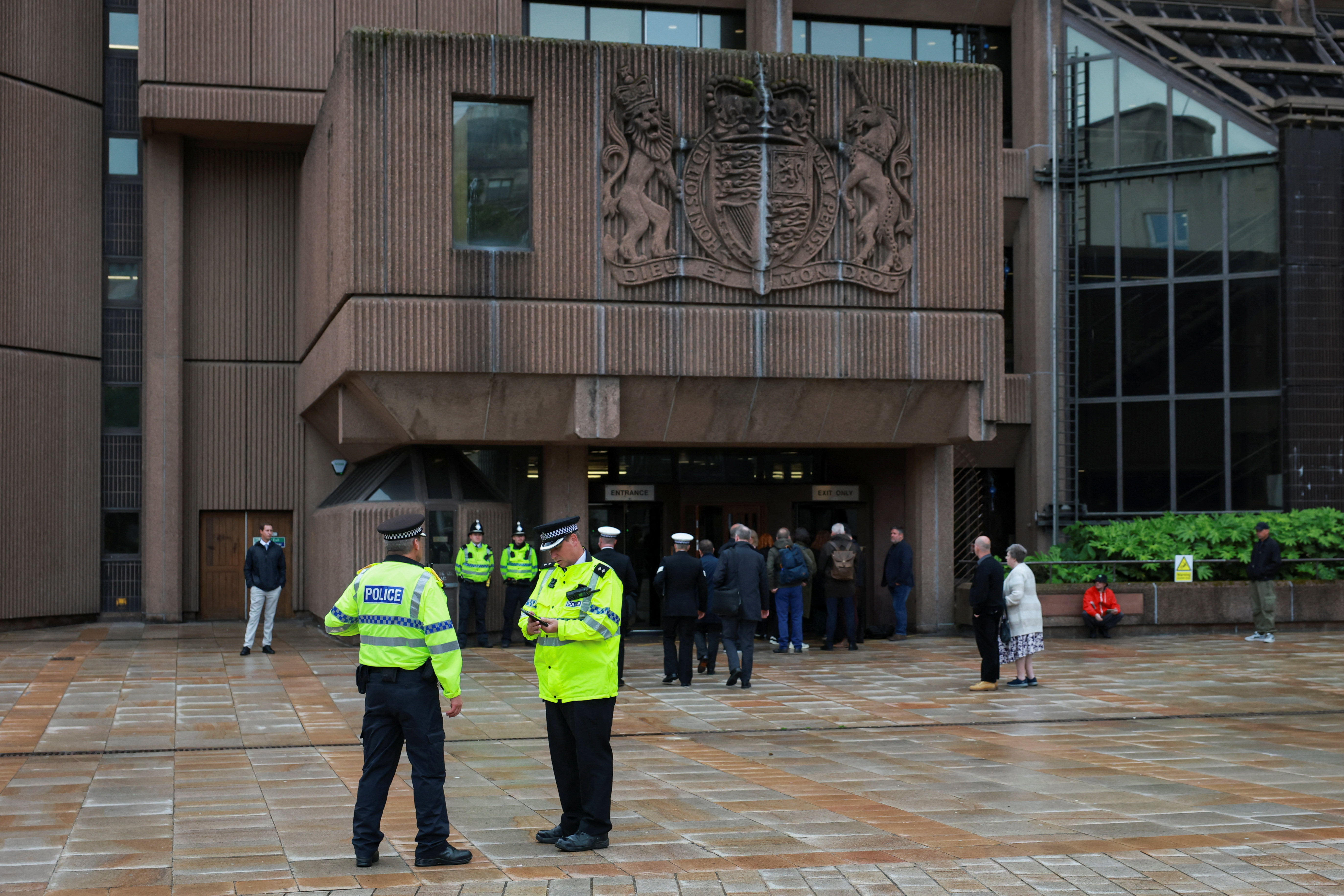 Police officers stand outside the entrance of the Liverpool Magistrates' Court