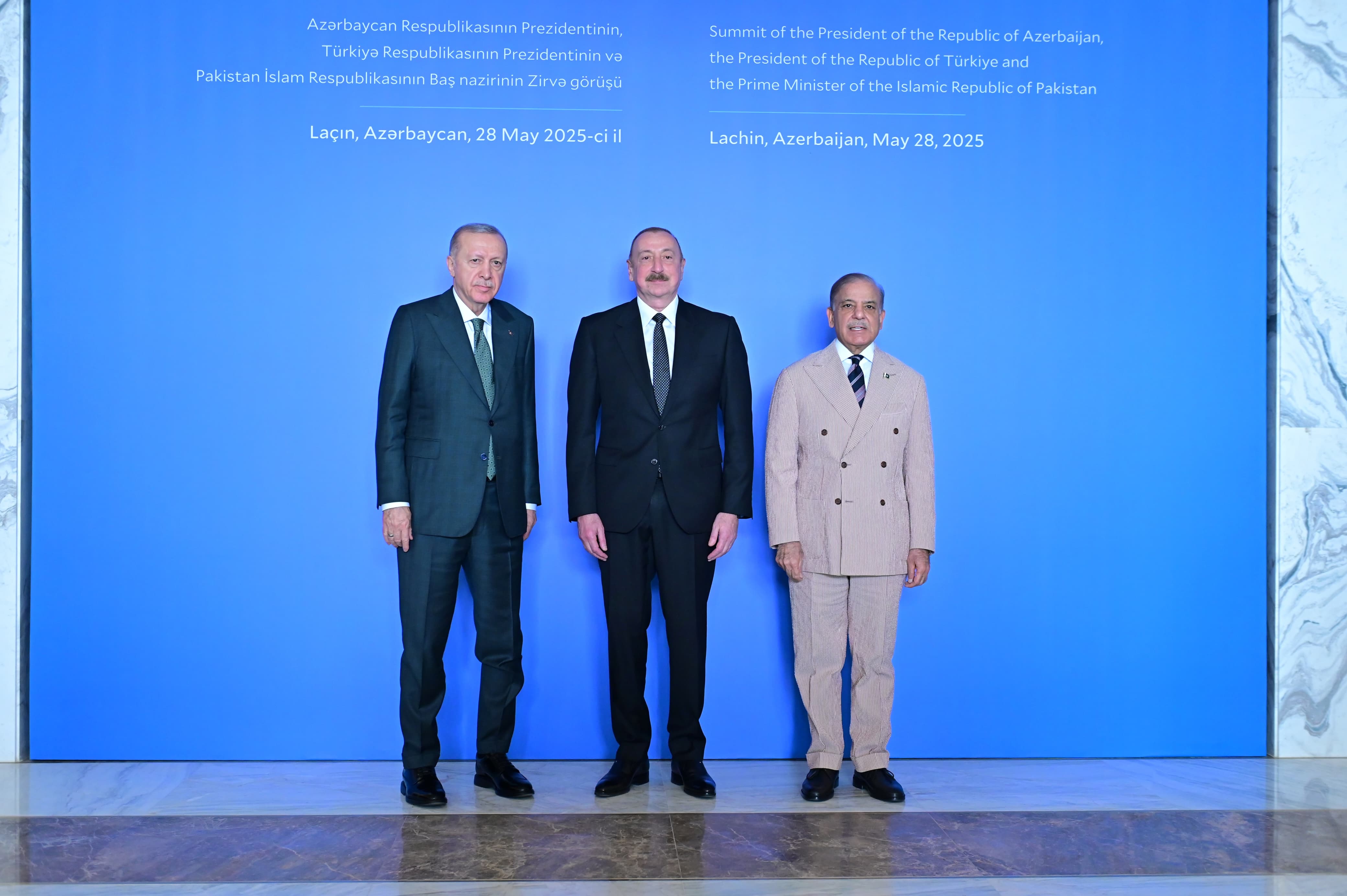 Pakistani Prime Minister Shehbaz Sharif, right, with Turkish President Recep Tayyip Erdogan, left, and President Ilham Aliyev of Azerbaijan, pose for a photo.