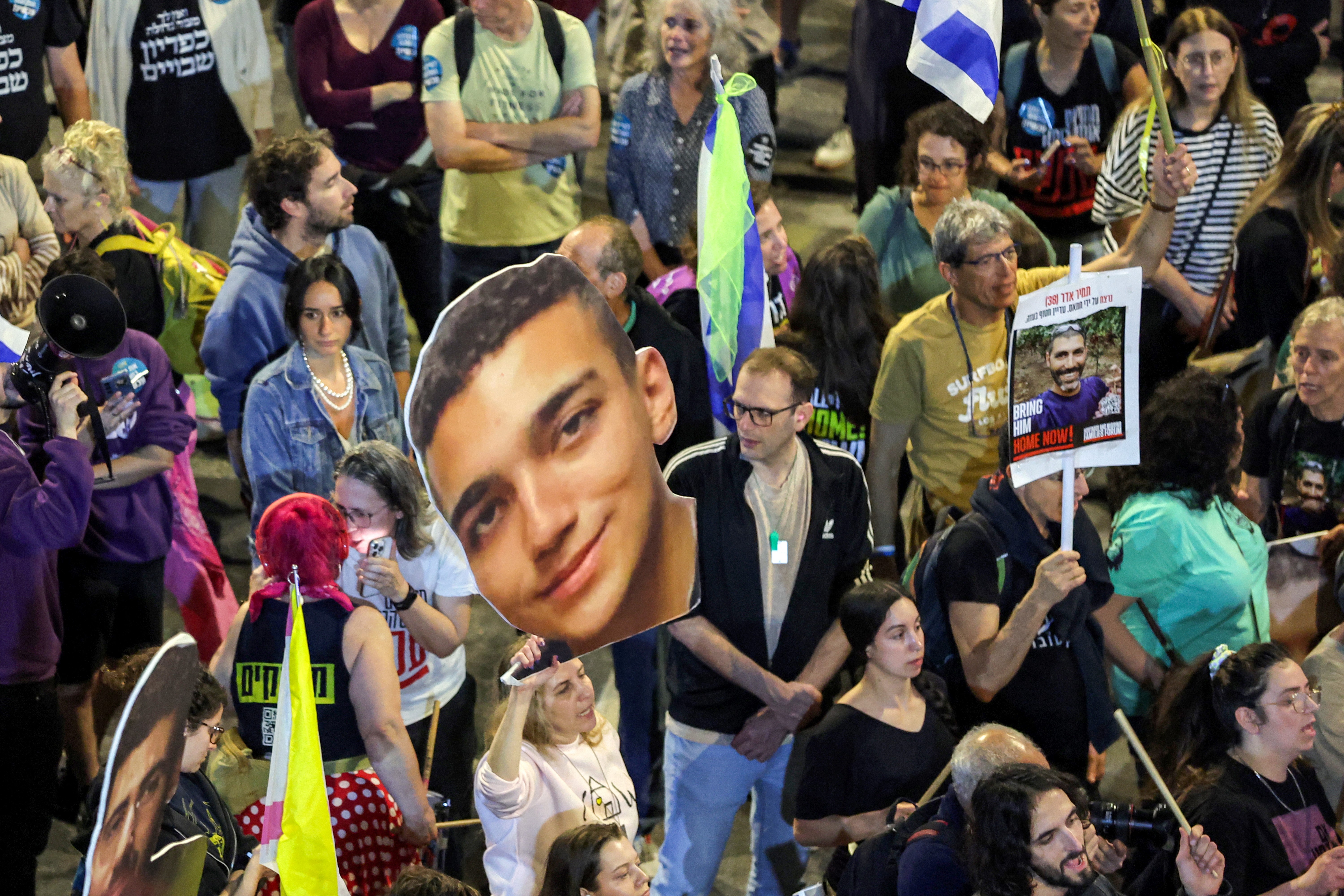 A demonstrator holds a sign showing the face of US-Israeli hostage Edan Alexander