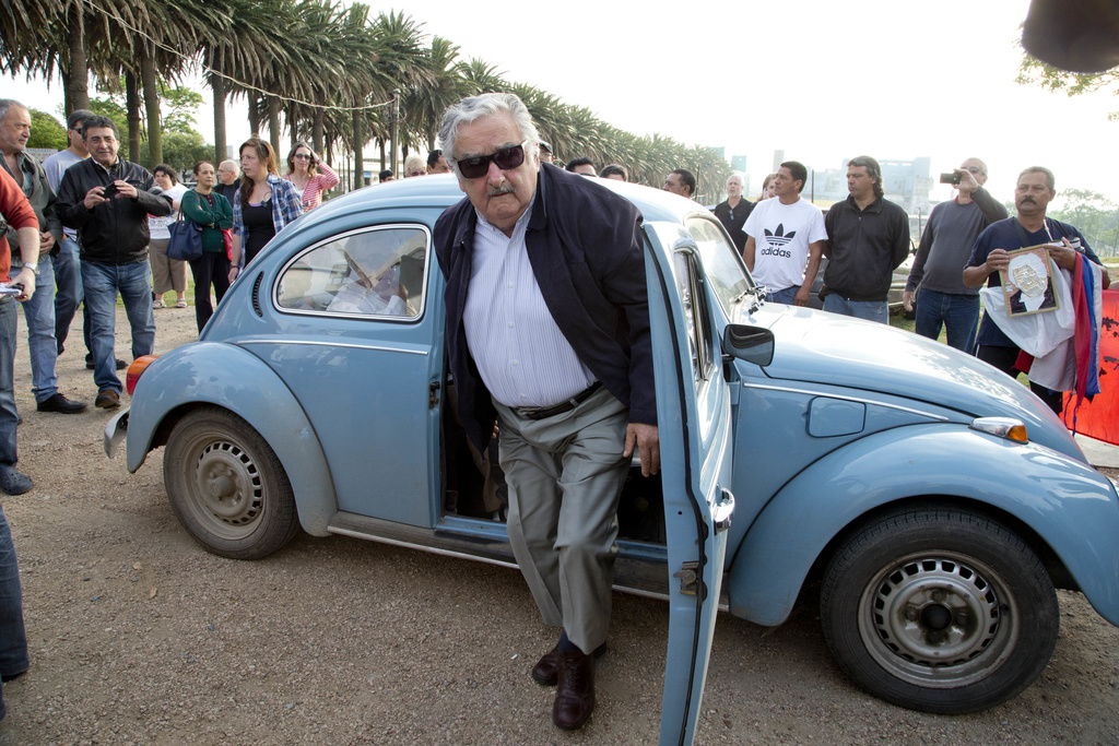 Mujica steps out of a VW Beetle