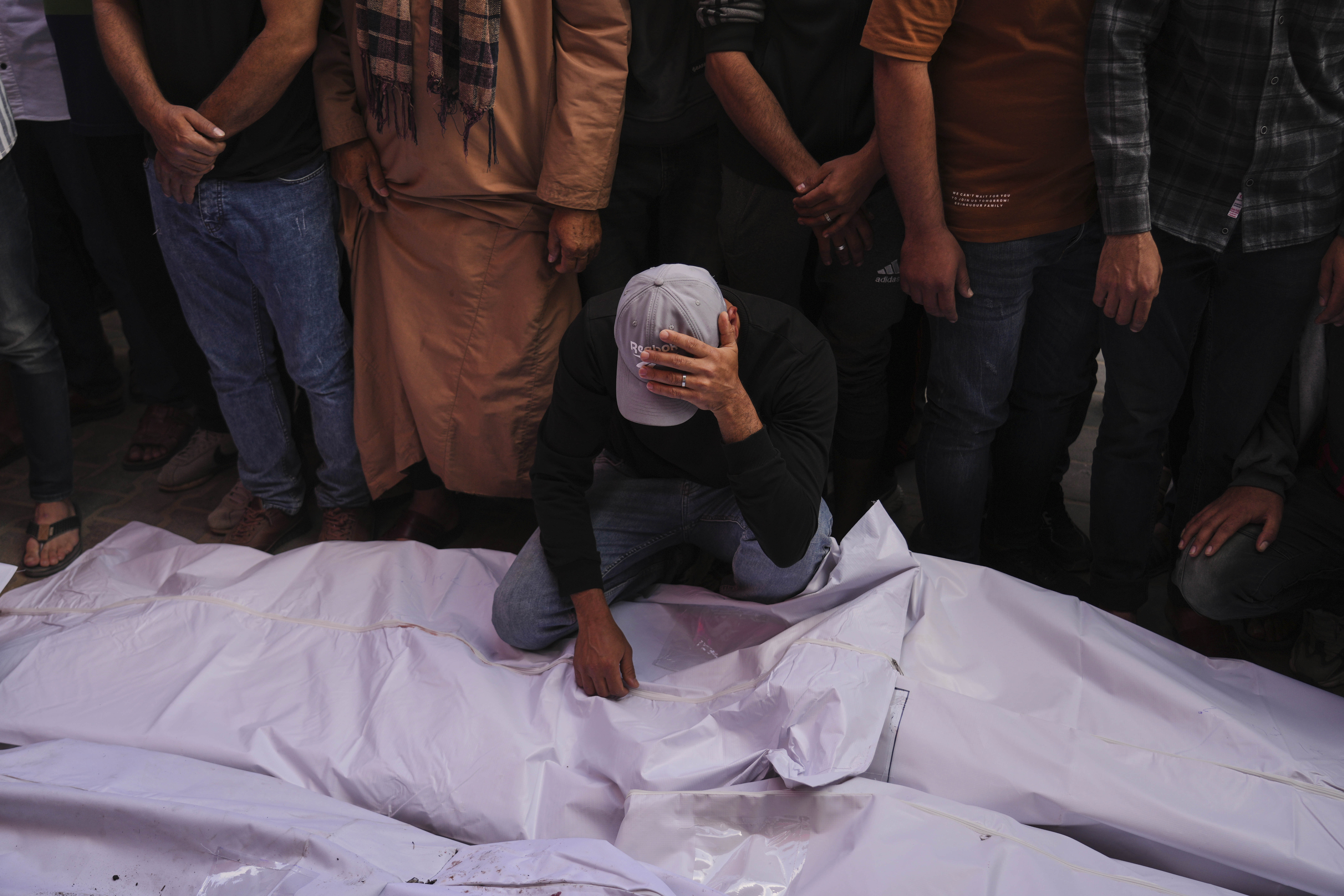 Palestinian mourn their relatives who were killed in an Israeli army airstrike on the Gaza Strip, at the morgue of Al-Aqsa Hospital in Deir al-Balah, Gaza, Tuesday, May 20, 2025. (AP Photo/Abdel Kareem Hana)