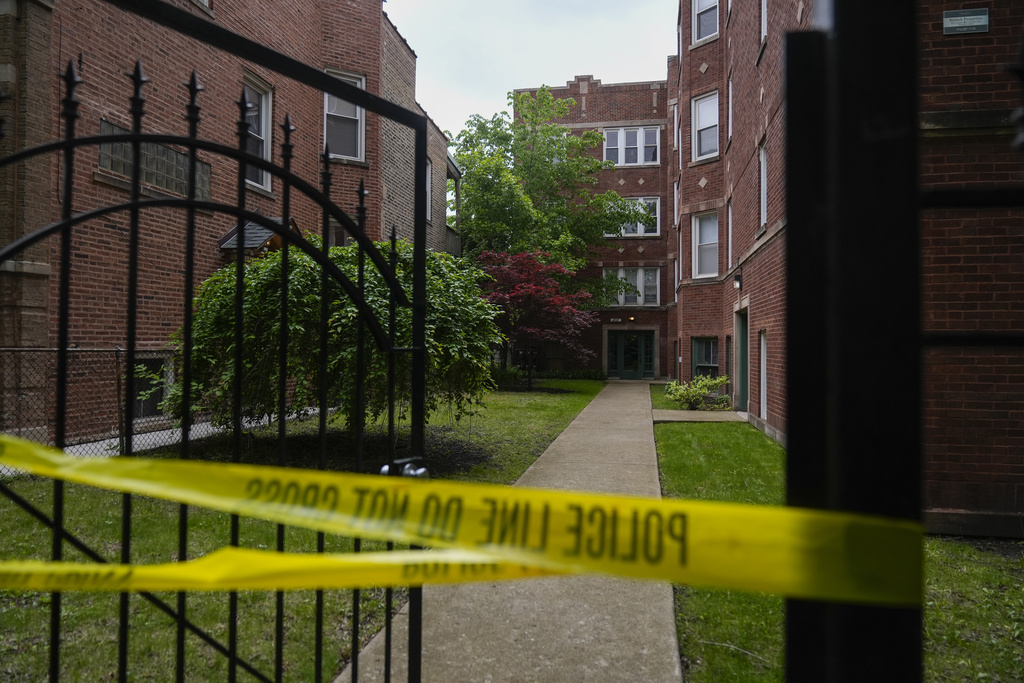 Police tape around the entrance of a building