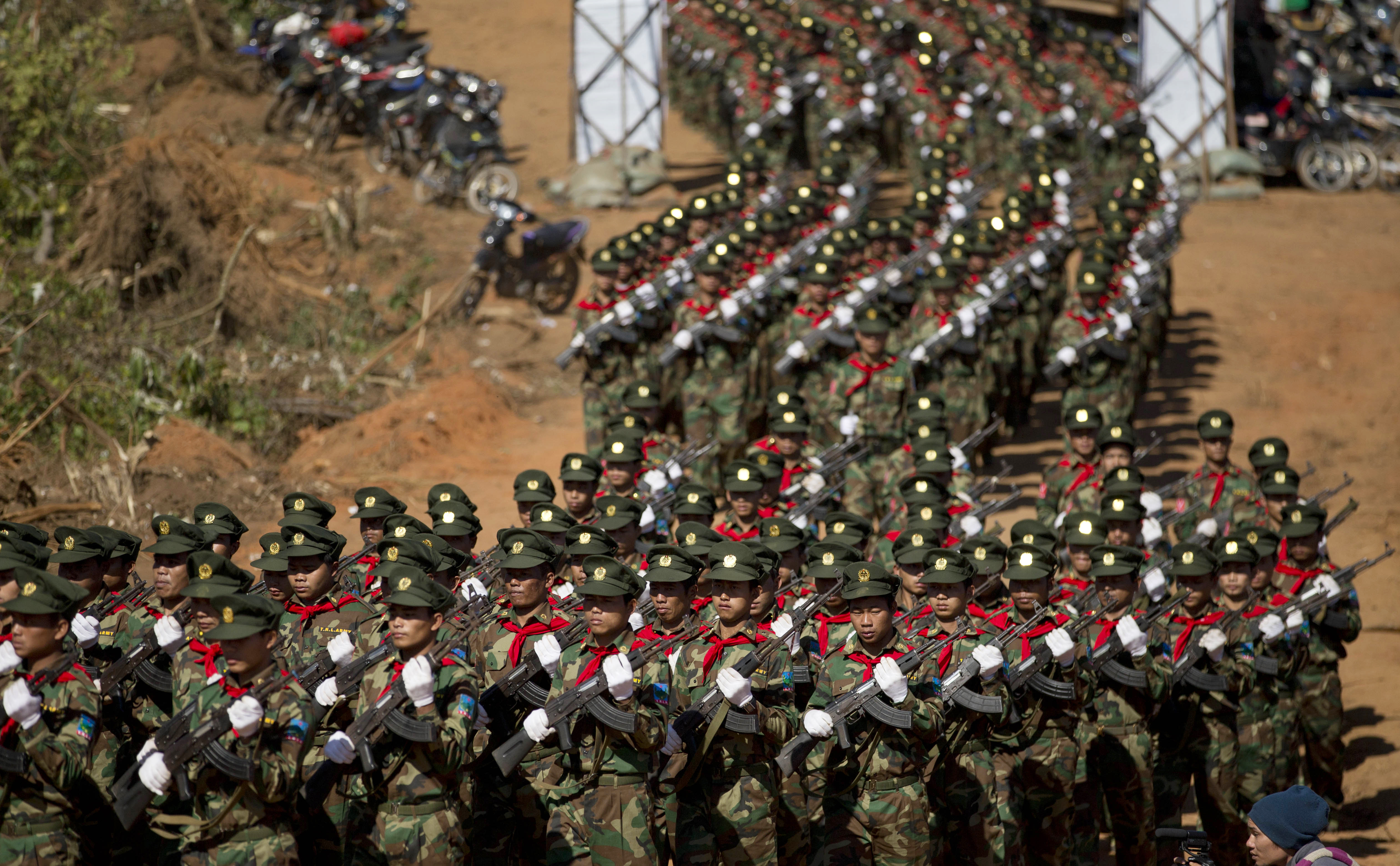 In this Jan. 12, 2015, photo, Taang National Liberation army officers march during a function to mark 52nd Ta'ang revolution day in Mar-Wong, Taang self-governing area, northern Shan state, Myanmar. Despite Aung San Suu Kyi's National League for Democracy party takes over power from a military-dominated regime from April 1, 2016 the Home Ministry, headed by a military-appointed minister, will retain its power over civil administration down to the village level as well as the police and domestic espionage.(AP Photo/Gemunu Amarasinghe)