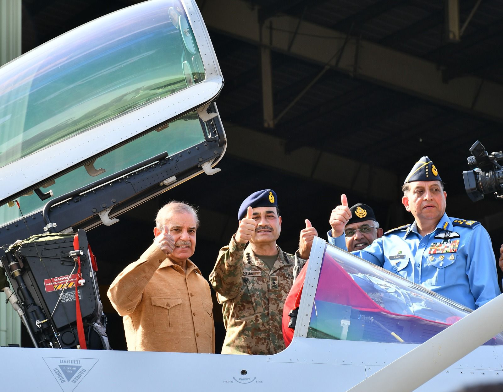 Pakistani prime minister Shehbaz Sharif, left, gives a thumbs up with General Syed Asim Munir, middle, and Air Chief Marshal Zaheer Ahmad Baber Sidhu, right, on May 15, 2025. [Handout via Prime minister's Office]
