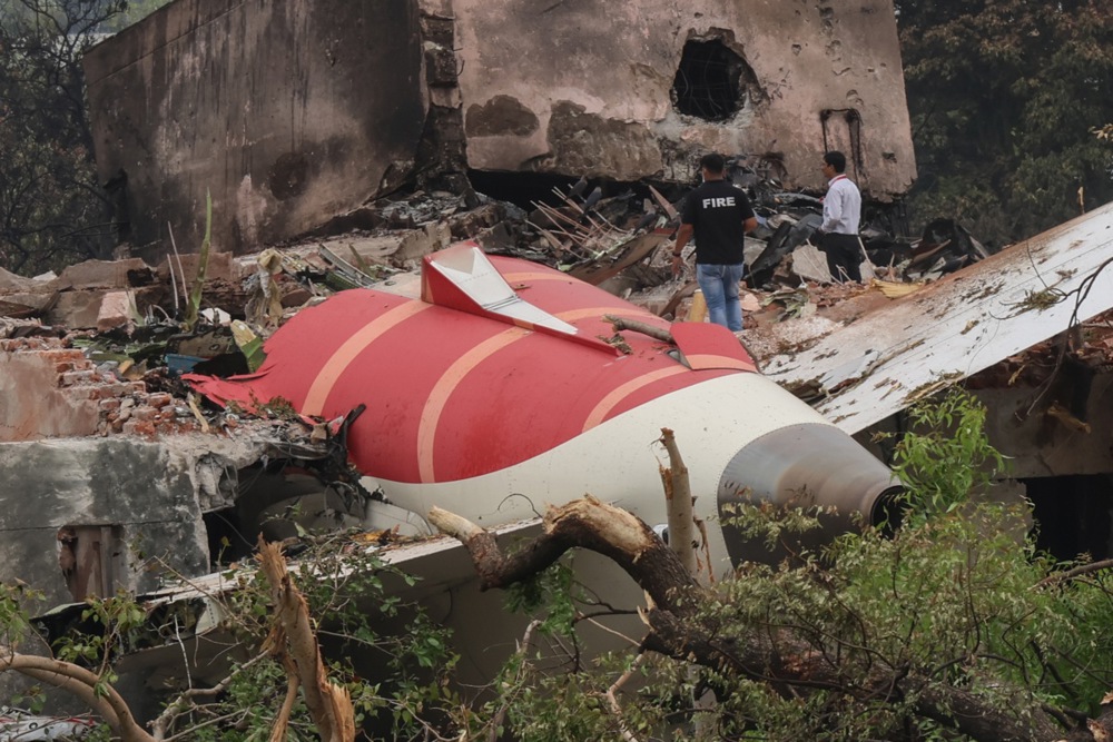 Officials inspect the site of the crash near Sardar Vallabhbhai Patel International Airport in Ahmedabad, Gujarat, western India, on June 13, 2025. Air India flight AI171, bound for London, carrying 242 passengers and crew members, crashed minutes after takeoff in the Meghani Nagar area of Ahmedabad
