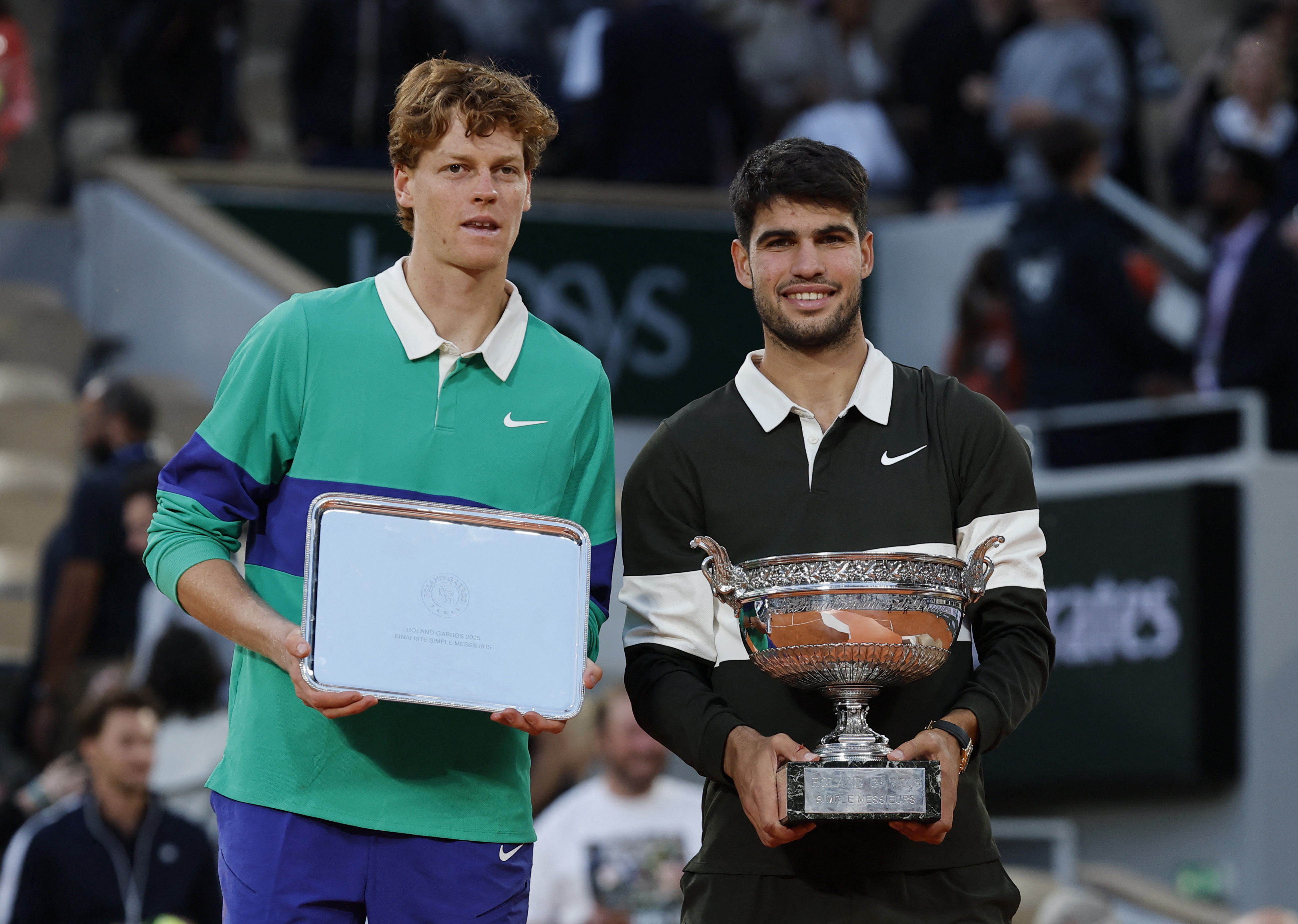 Spain's Carlos Alcaraz poses with the trophy after winning the men's singles final alongside runner up Italy's Jannik Sinner