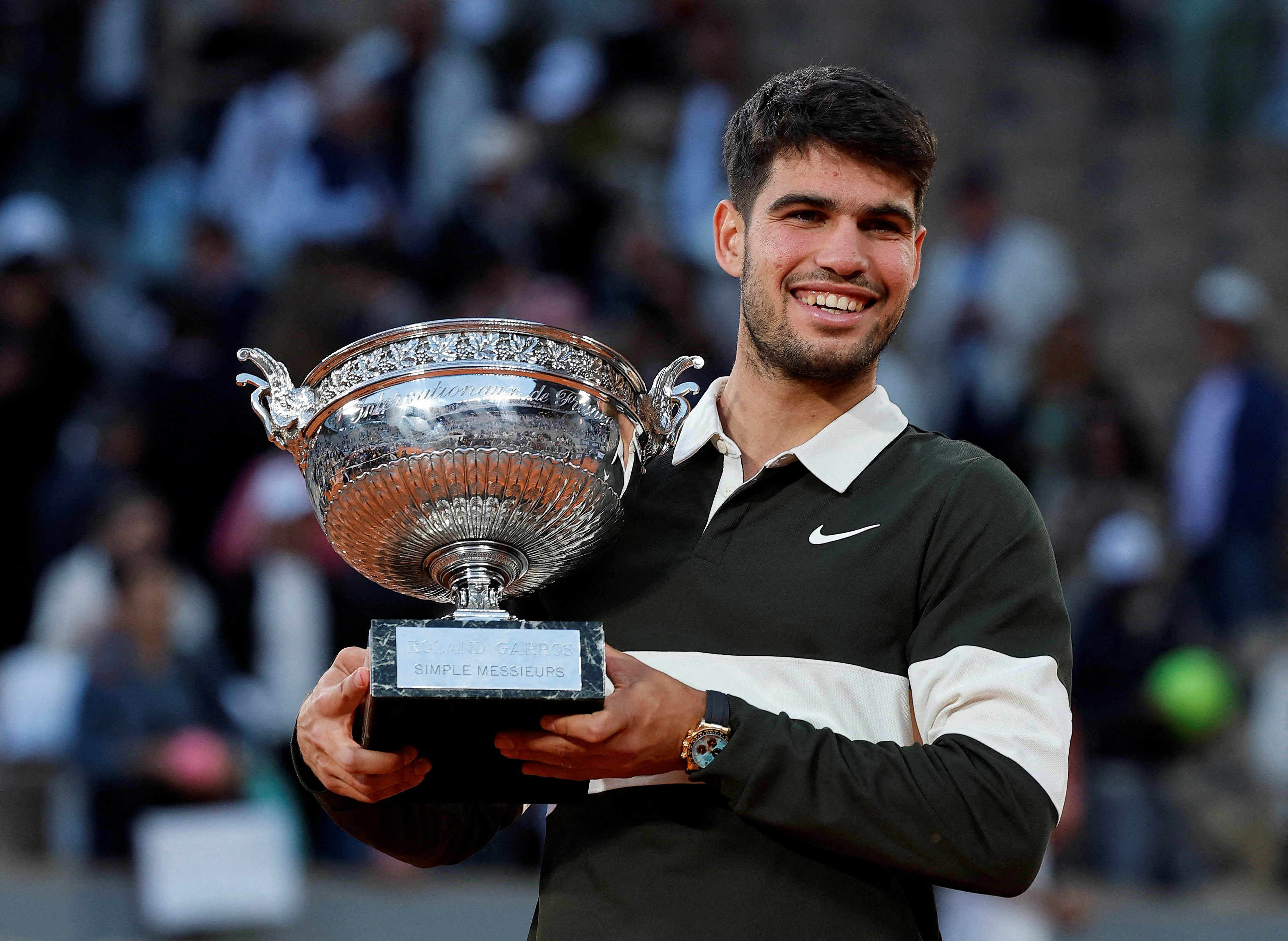 French Open - Roland Garros, Paris, France - June 8, 2025 Spain's Carlos Alcaraz celebrates with the trophy after winning the men's singles final against Italy's Jannik Sinner