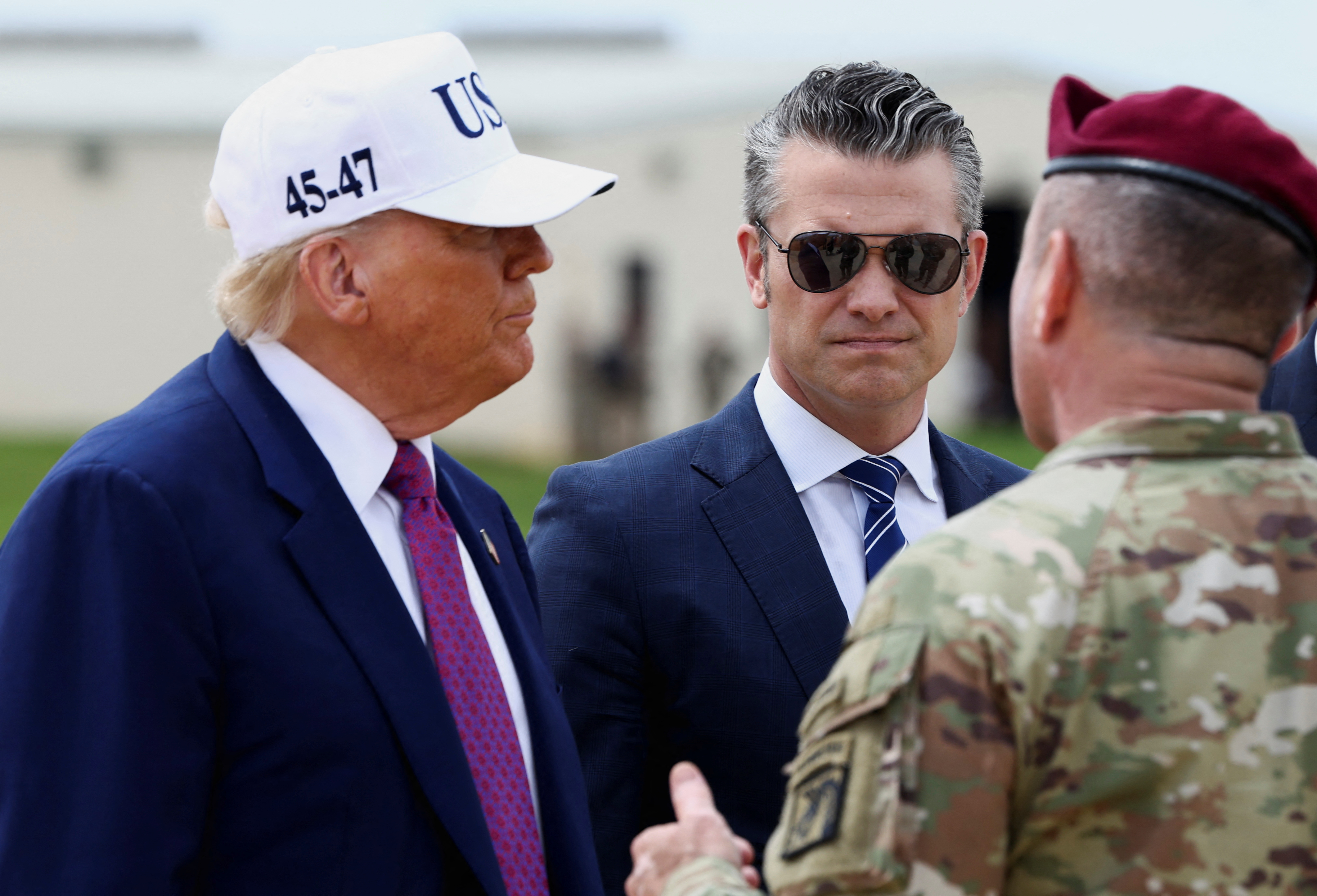 U.S. President Donald Trump, next to U.S. Defense Secretary Pete Hegseth, speaks with an Army member during a visit to Fort Bragg to mark the U.S. Army anniversary, in North Carolina, U.S., June 10, 2025. REUTERS/Evelyn Hockstein