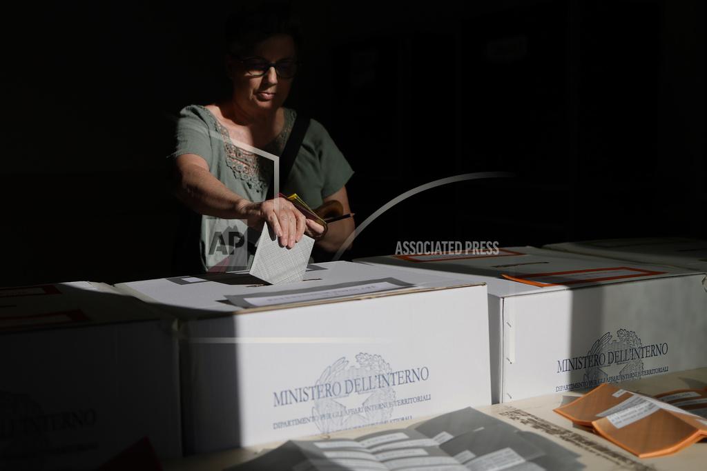 A woman casts her ballots on referendums on citizenship and job protections, at a polling station in Rome, Sunday, June 8, 2025. [Cecilia Fabiano/LaPresse via AP]