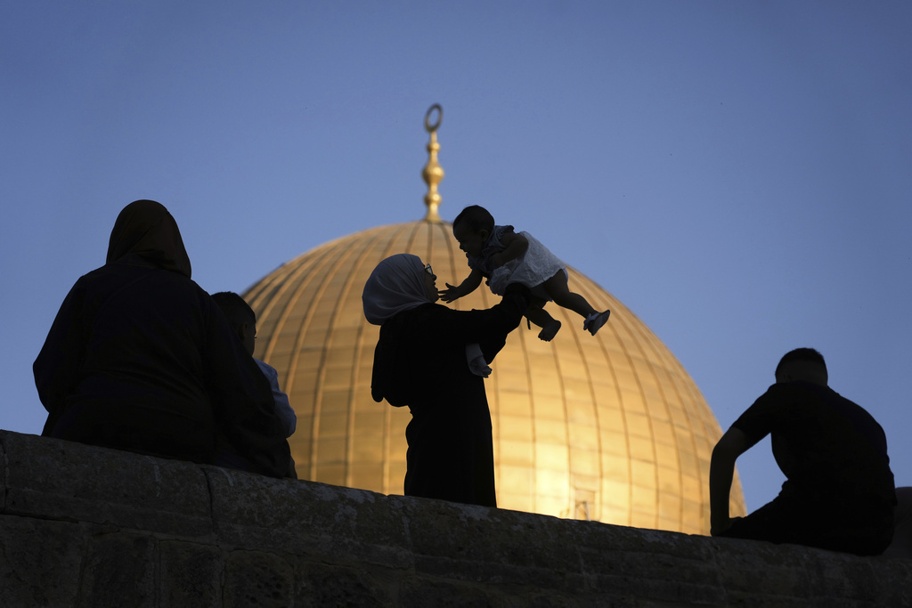 Muslim worshipers gather for Eid al-Adha prayers next to the Dome of the Rock shrine at the Al Aqsa Mosque compound in Jerusalem