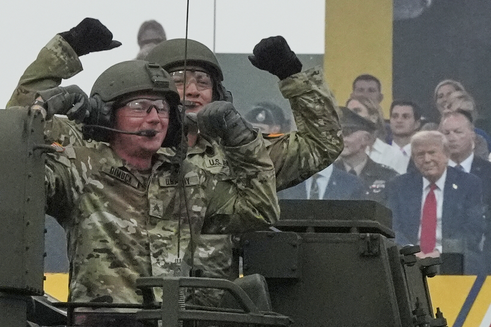 Soldiers cheer as President Donald Trump watches the military parade commemorating the US Army's 250th anniversary in Washington, DC