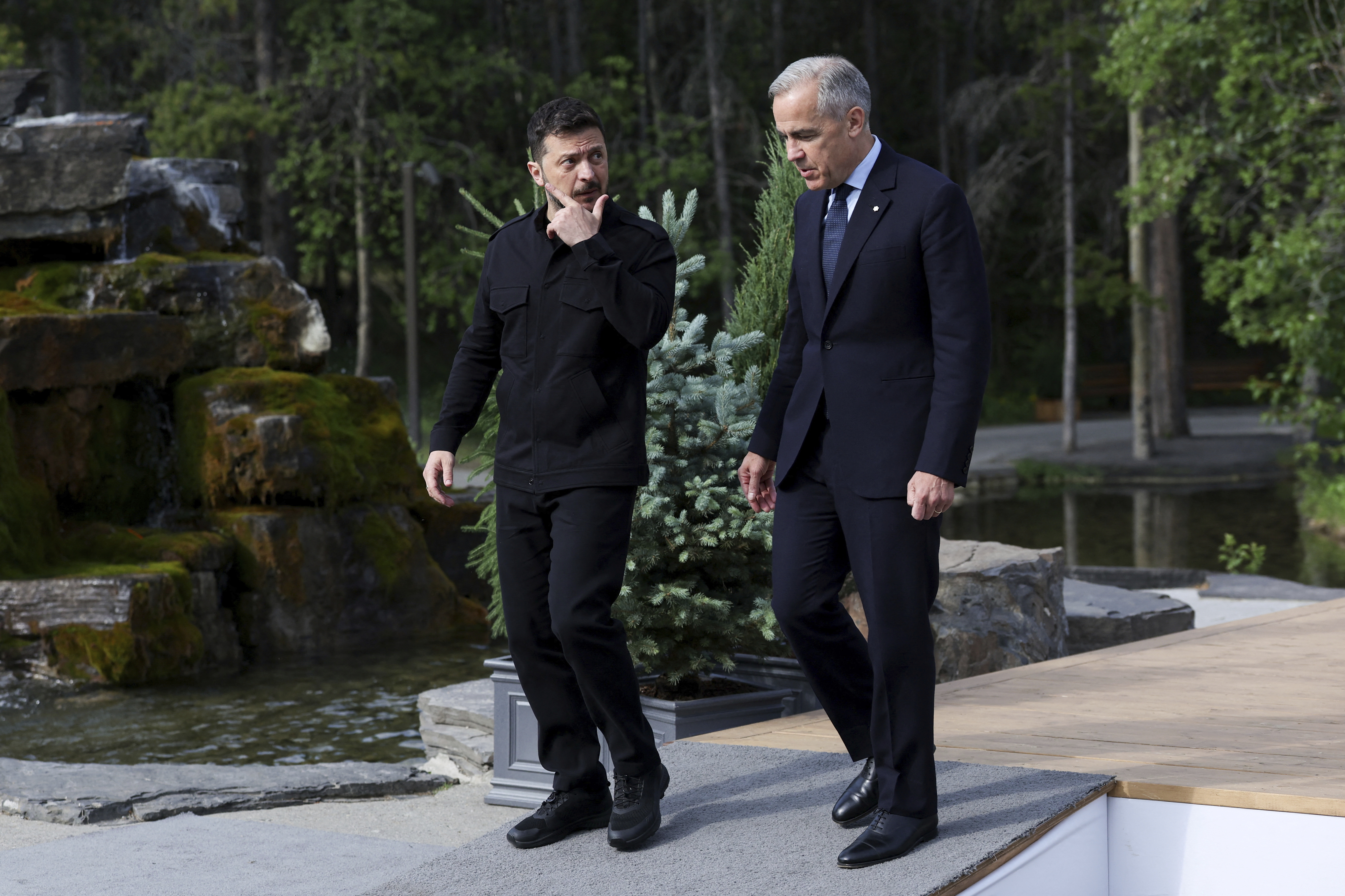 Canadian Prime Minister Mark Carney walks with Ukraine's President Volodymyr Zelenskyy during the G7 Leaders' Summit in Kananaskis, in Alberta, Canada