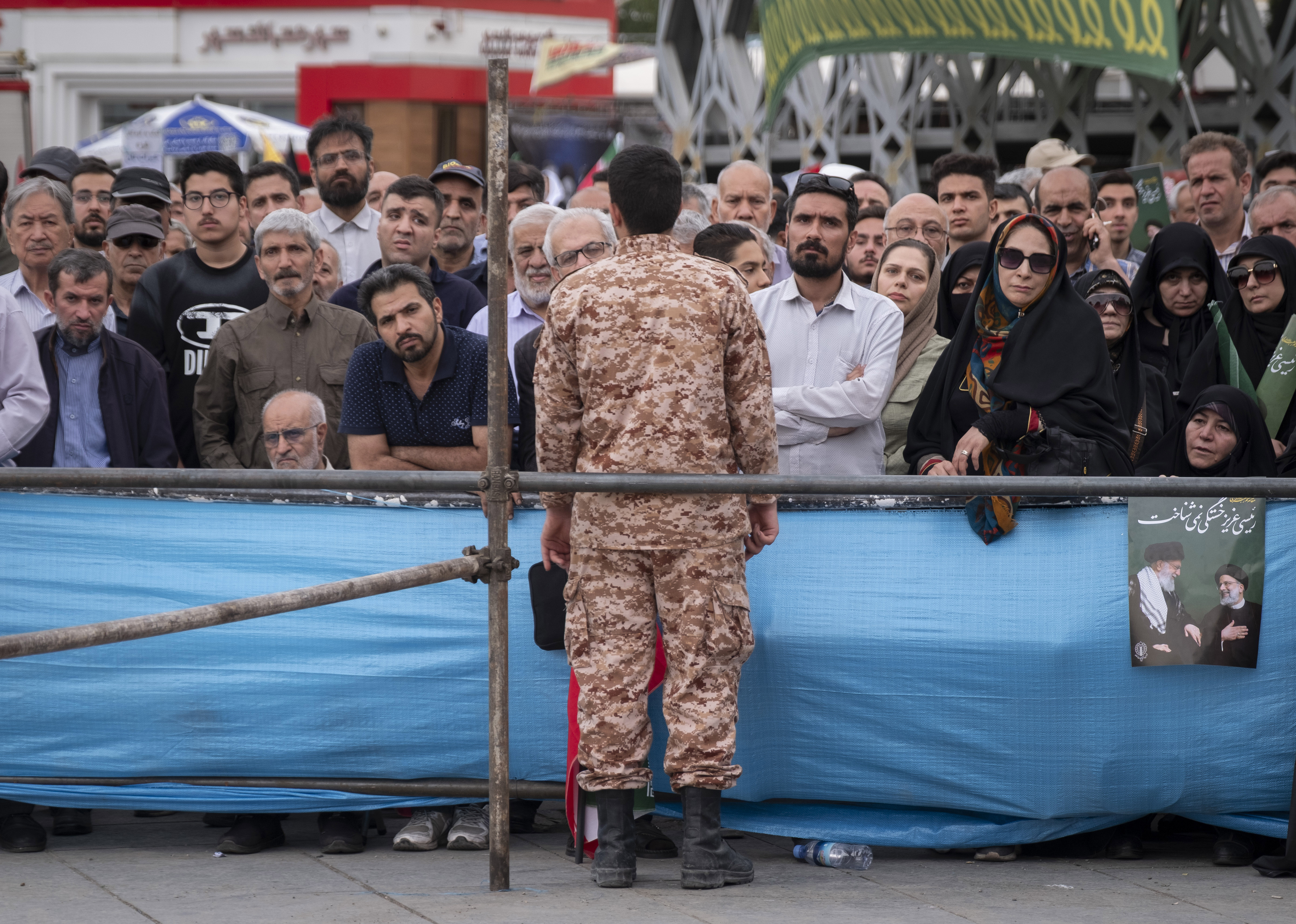An IRGC soldier monitors a ceremony in Tehran