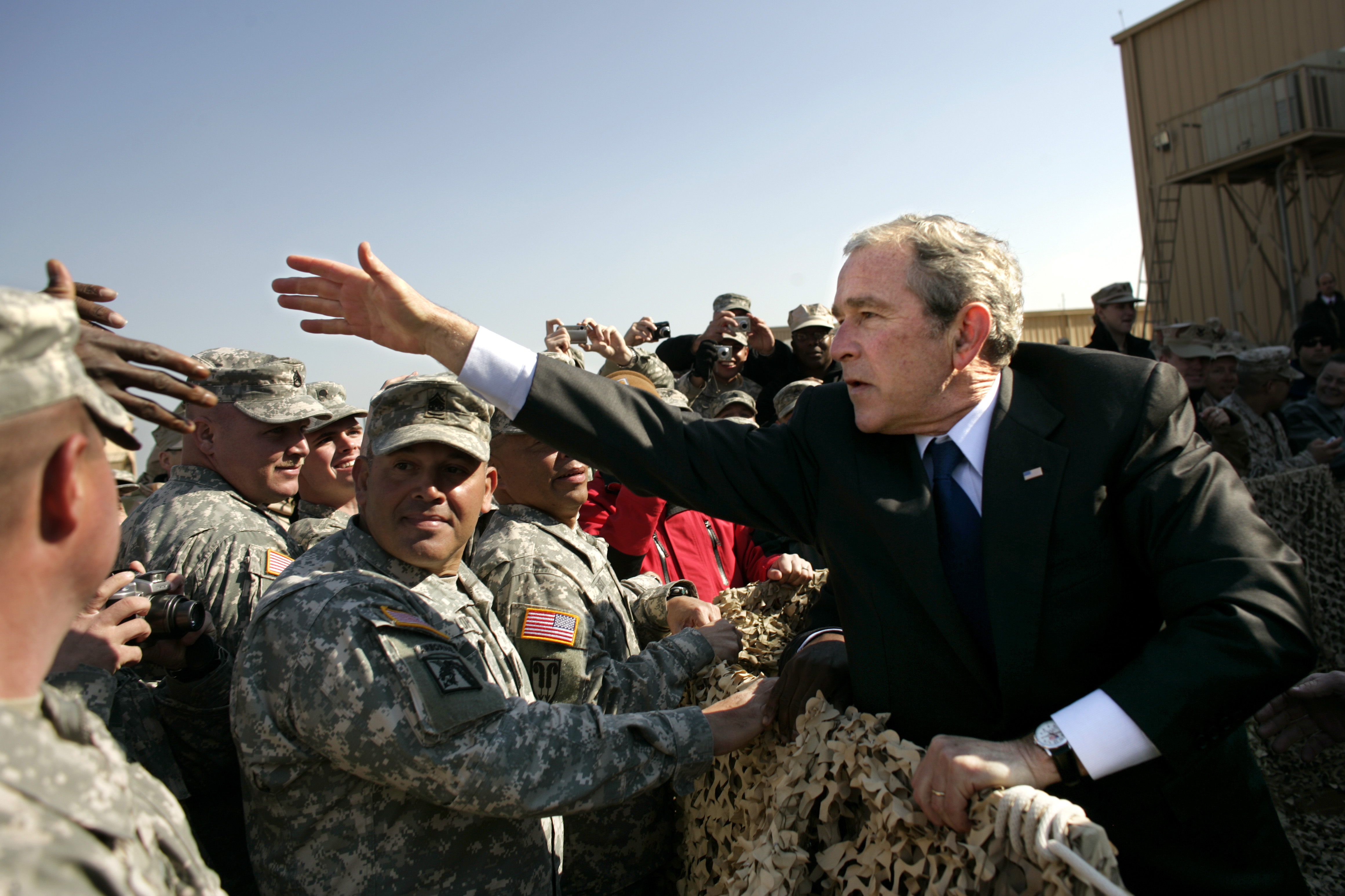 US President George W. Bush greets military personnel in Camp Arifjan, Kuwait. Bush is visiting this sprawling military base, the largest US base in Kuwait which is home to some 9,000 American troops during his scheduled tour of the region. (Photo by Brooks Kraft LLC/Corbis via Getty Images)