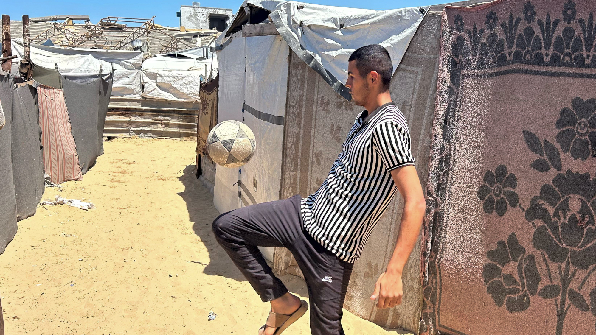 Man juggles football in Gaza.