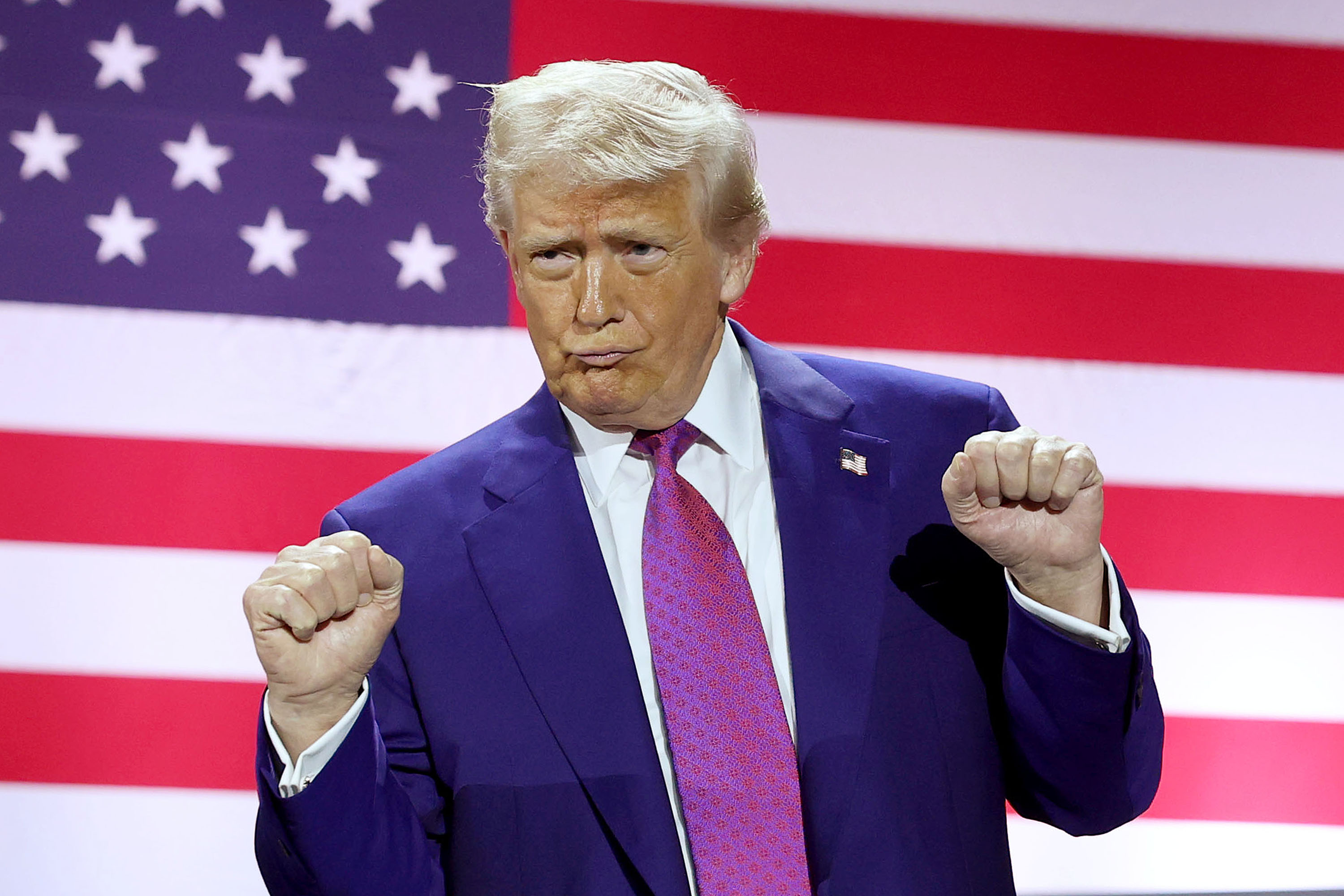 Donald Trump gestures on stage.