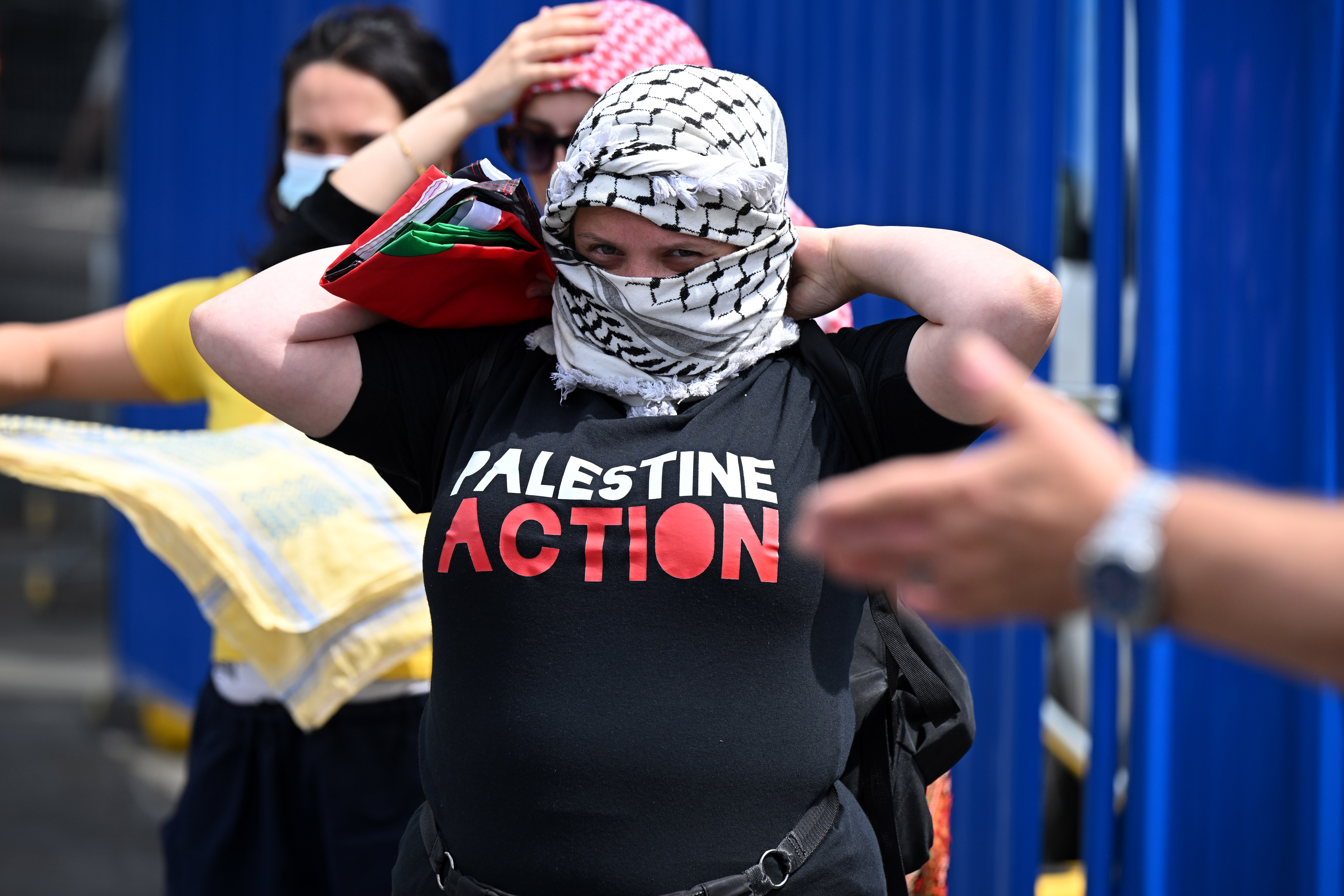 A protester wearing a 'Palestine Action' T-shirt takes part in a demonstration.