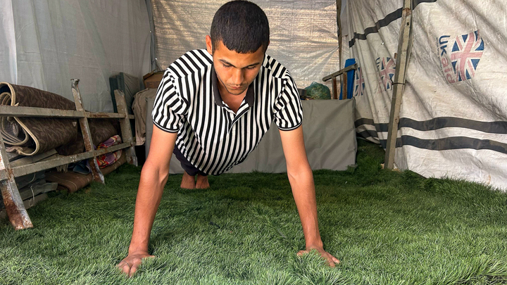 Yousef Abu Shawarib fitness training inside his tent.