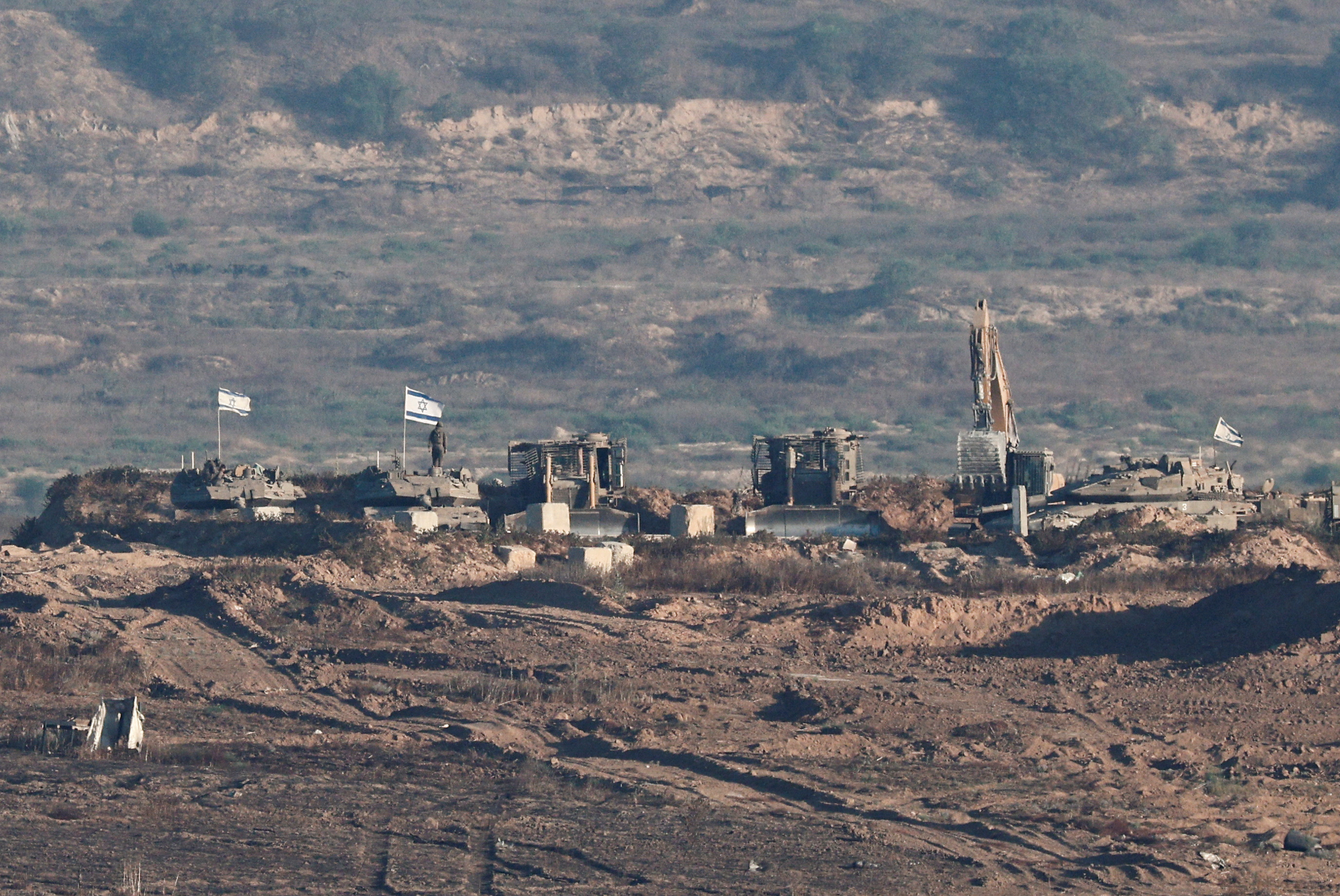 Israeli soldiers and military vehicles operate in Gaza