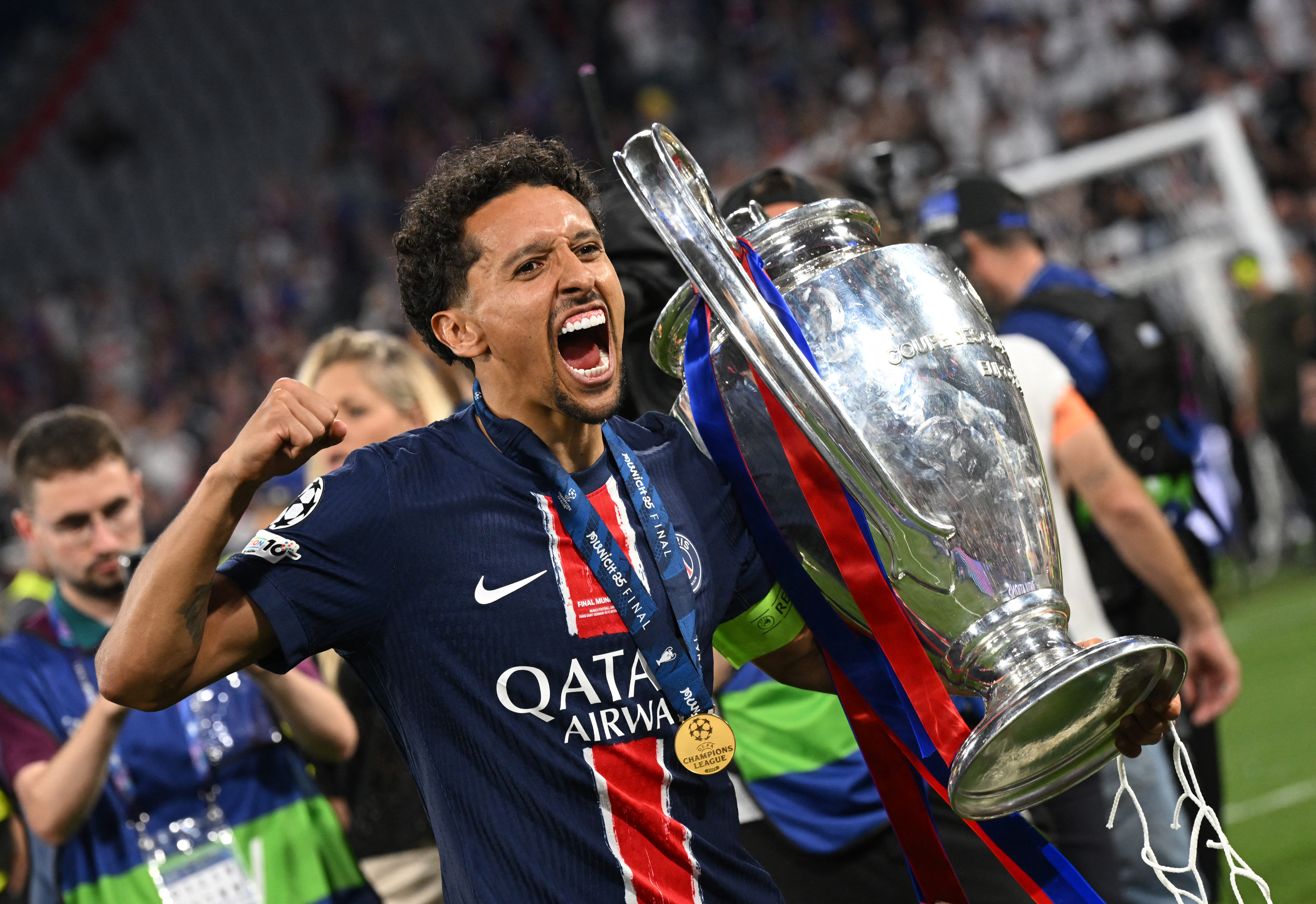 Paris Saint-Germain's Marquinhos celebrates with the trophy.