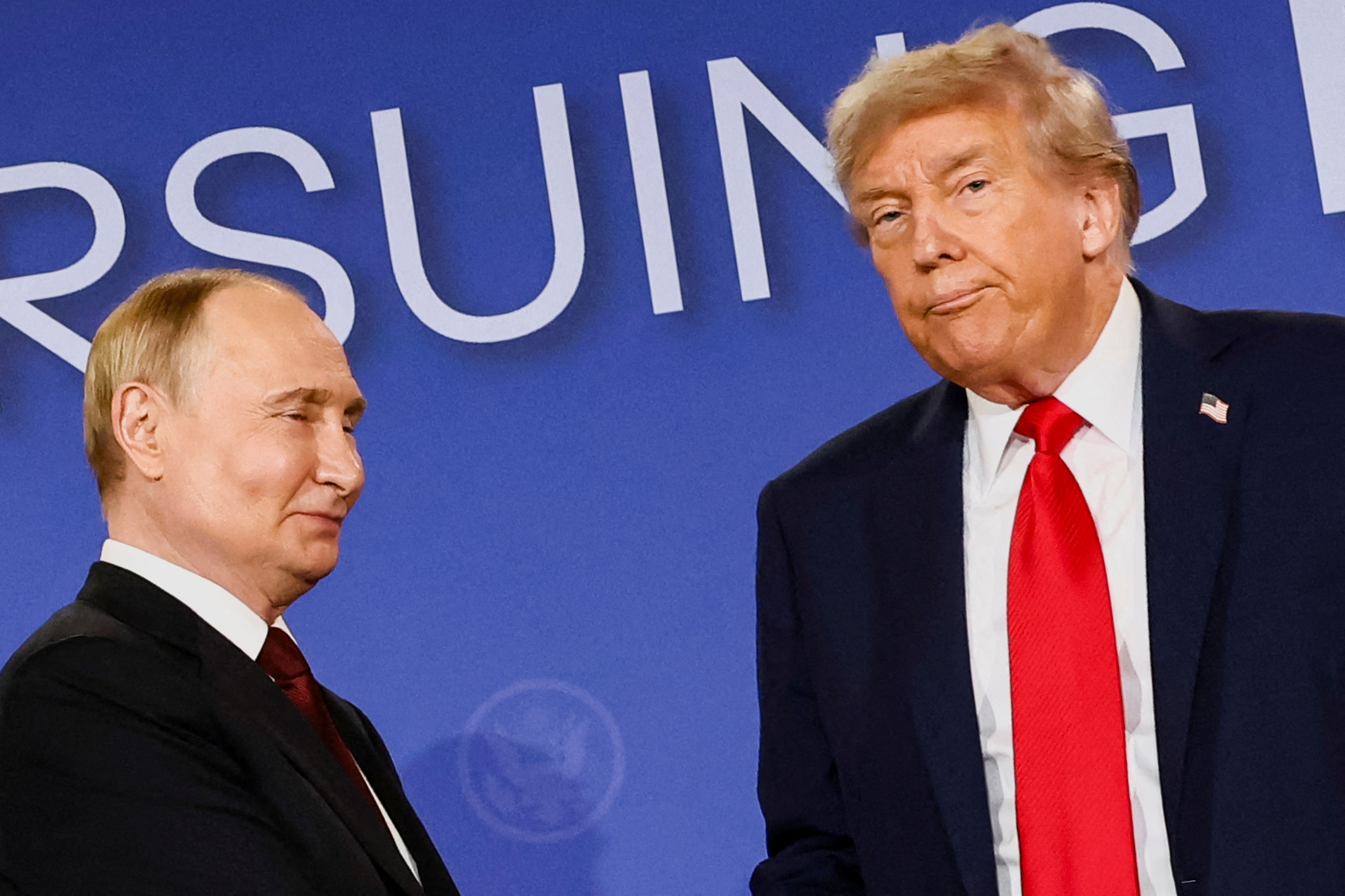 U.S. President Donald Trump looks on next to Russian President Vladimir Putin during a press conference following their meeting to negotiate an end to the war in Ukraine, at Joint Base Elmendorf-Richardson, in Anchorage, Alaska, U.S., August 15, 2025. REUTERS/Kevin Lamarque TPX IMAGES OF THE DAY
