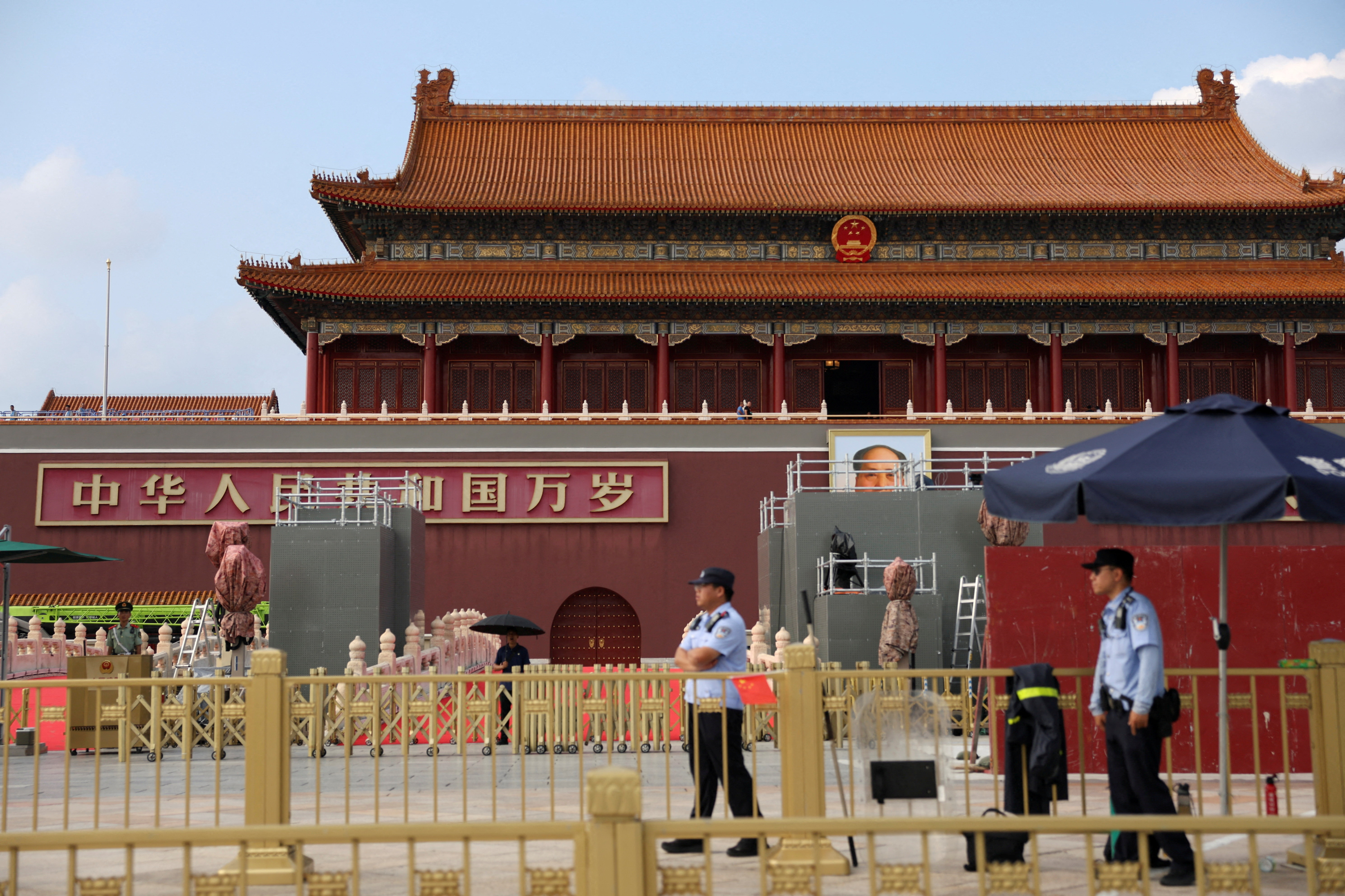 Police officers stand guard in front of the Tiananmen Gate, in an area temporarily closed to visitors due to construction, in advance of a military parade marking the 80th anniversary of the end of World War II, in Beijing, China, on August 20, 2025 [Florence Lo/Reuters]