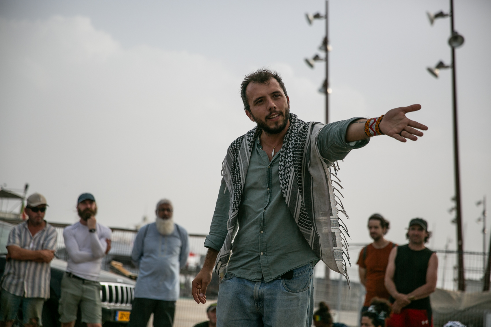 Thiago Avila in focus in the foreground, with volunteers in the background
