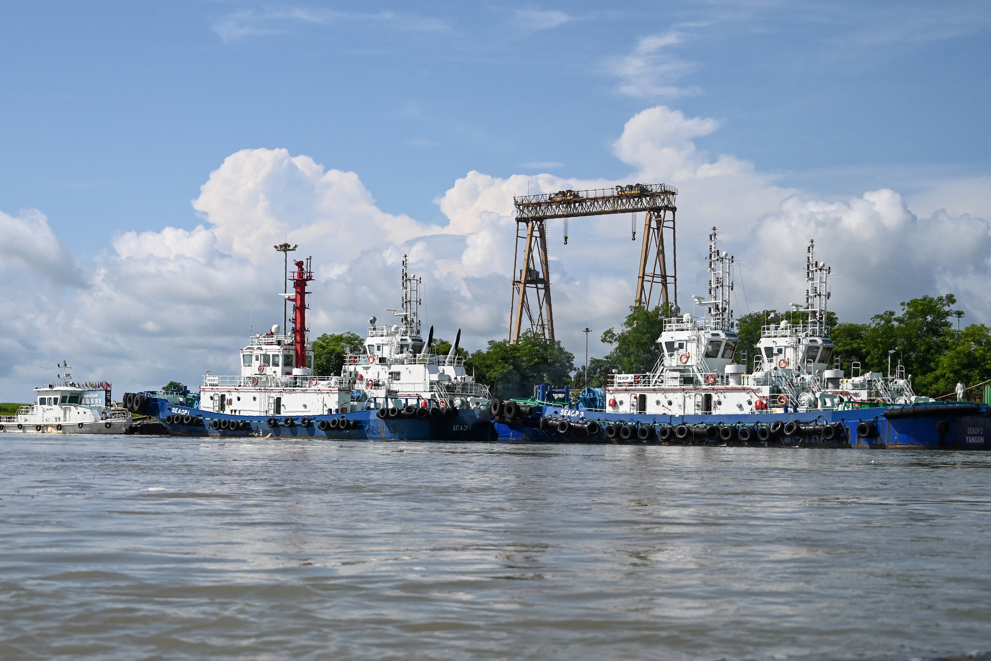 This photo taken from a boat on October 2, 2019 shows vessels docked at a port of a Chinese-owned oil refinery plant on Made Island off Kyaukphyu, Rakhine State. Myanmar has declared Rakhine state -- associated by many worldwide with the military's 2017 crackdown on Rohingya Muslims -- open for business. Beijing is now poised to cement its grip on the area with the deep-sea port, signed off in November 2018, and a colossal Special Economic Zone (SEZ) of garment and food processing factories. (Photo by Ye Aung THU / AFP) / TO GO WITH MYANMAR-CHINA-ECONOMY, FEATURE BY RICHARD SARGENT AND SU MYAT MON