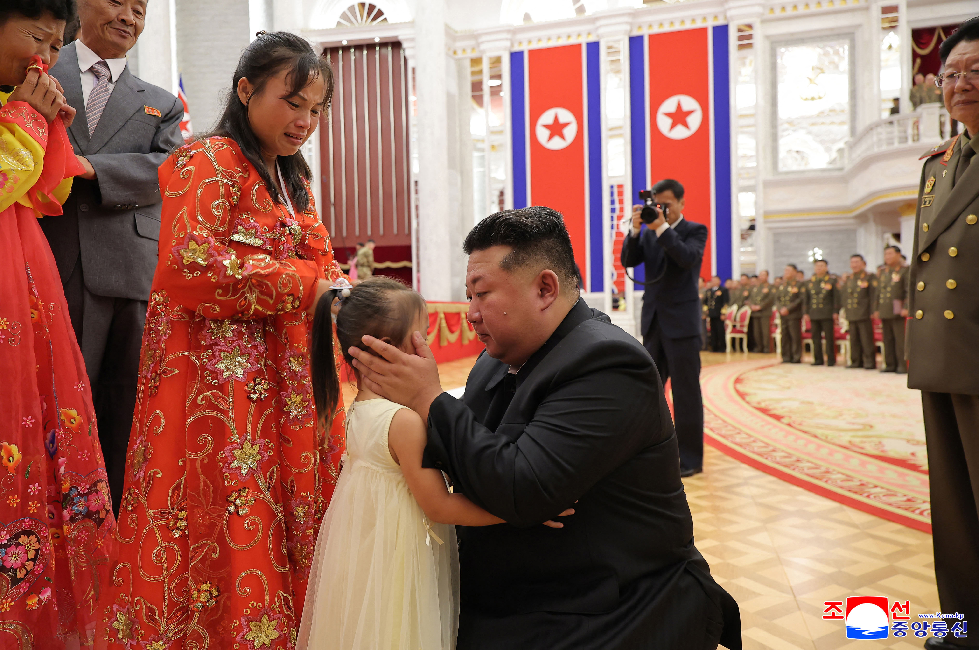 This undated picture released from North Korea's official Korean Central News Agency (KCNA) on August 22, 2025 shows North Korean leader Kim Jong Un meeting with bereaved families during a ceremony to award state commendations to the commander and combatants of the Korean People's Army's Overseas Operational Forces, who took part in military operations in Kursk Oblast to help Russia in its war against Ukraine, at the headquarters building of the Central Committee of the The Workers' Party of Korea (WPK) in Pyongyang.