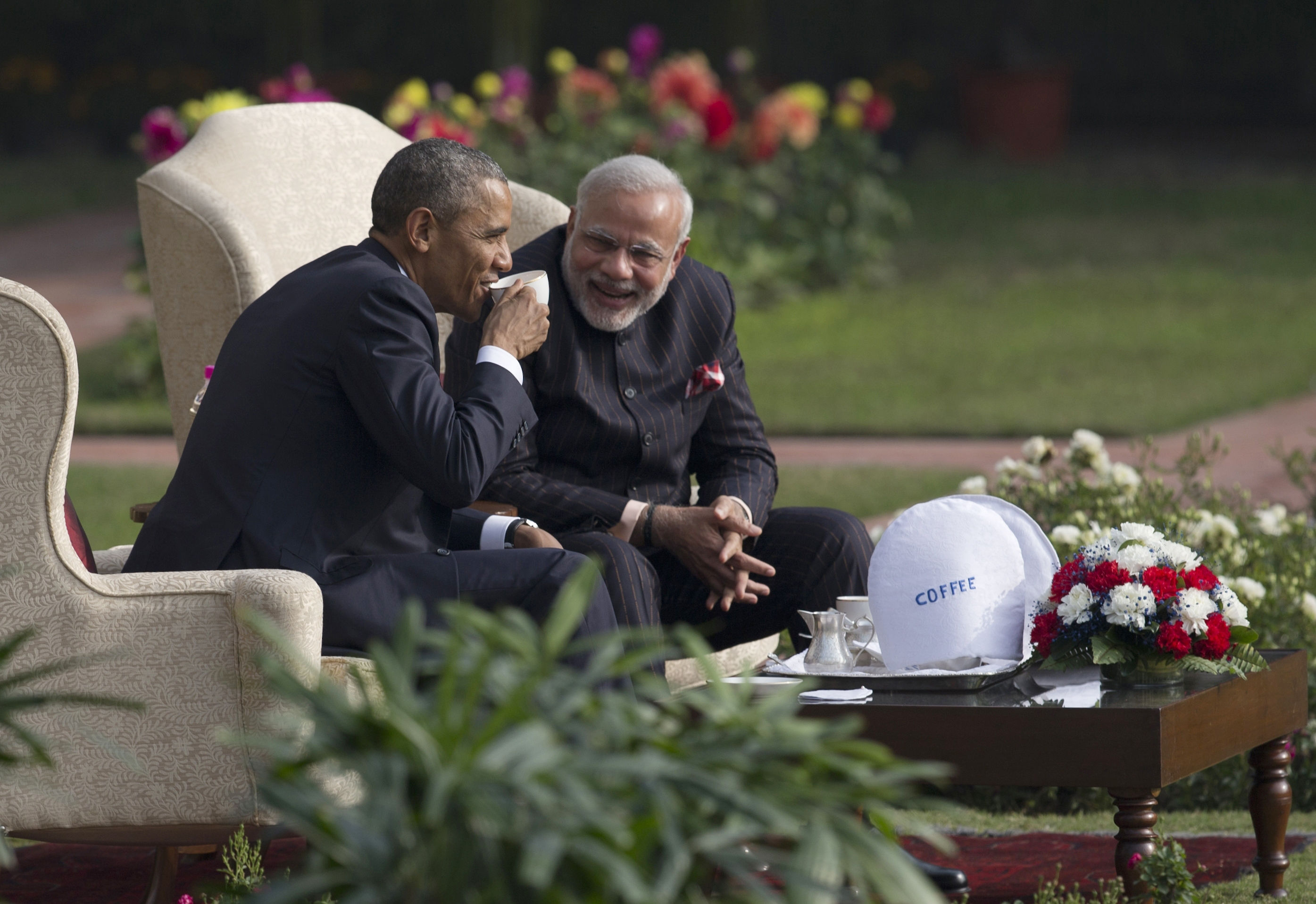 FILE - In this Sunday, Jan. 25, 2015 file photo, President Barack Obama, left, and Indian Prime Minister Narendra Modi have coffee and tea in the gardens of the Hyderabad House in New Delhi, India. As Barack Obama embarks on what is likely to be his final trip to Asia as president, attention is returning to what is known as the U.S. "pivot" to the continent launched during his first term. The policy adjustment aimed to reinforce alliances and shift military assets to a region that has grown in importance alongside the rise of China as a global economic and political power. (AP Photo/Carolyn Kaster, File)
