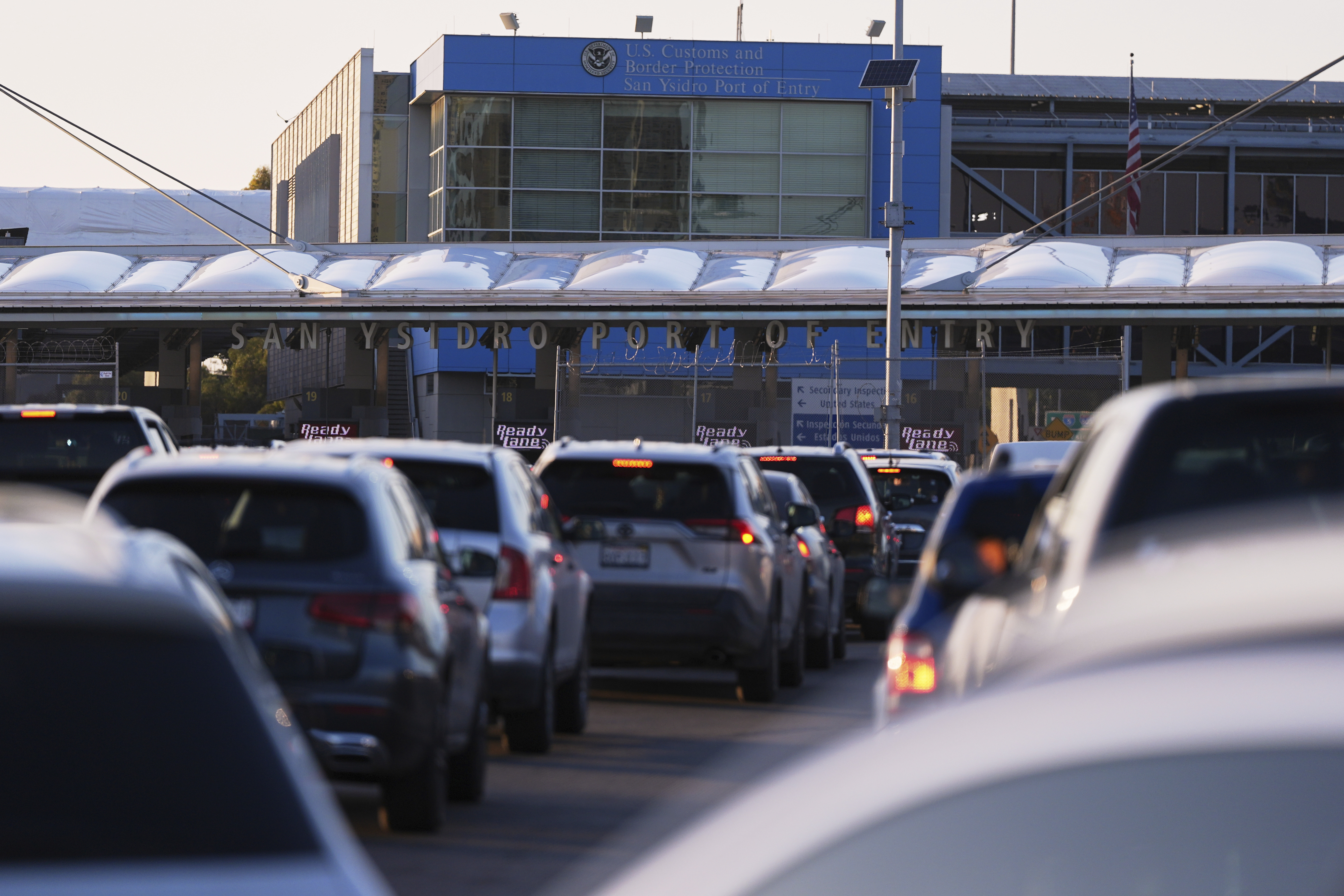 Vehicles wait in line to cross the border into the United States at the San Ysidro Port of Entry, Tuesday, March 18, 2025, in Tijuana, Mexico. (AP Photo/Gregory Bull)