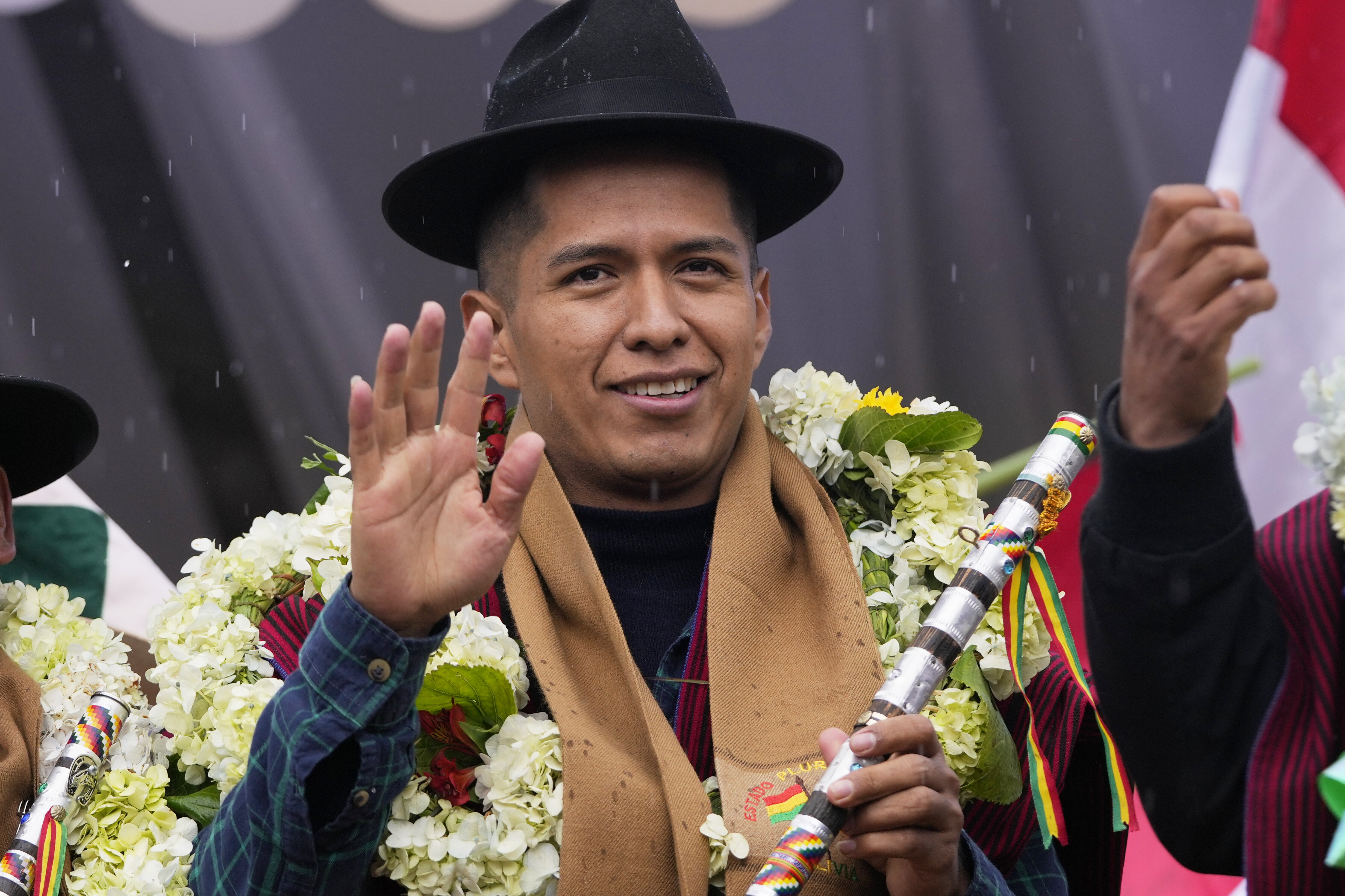 Andronico Rodriguez in a felt hat and flower garlands.