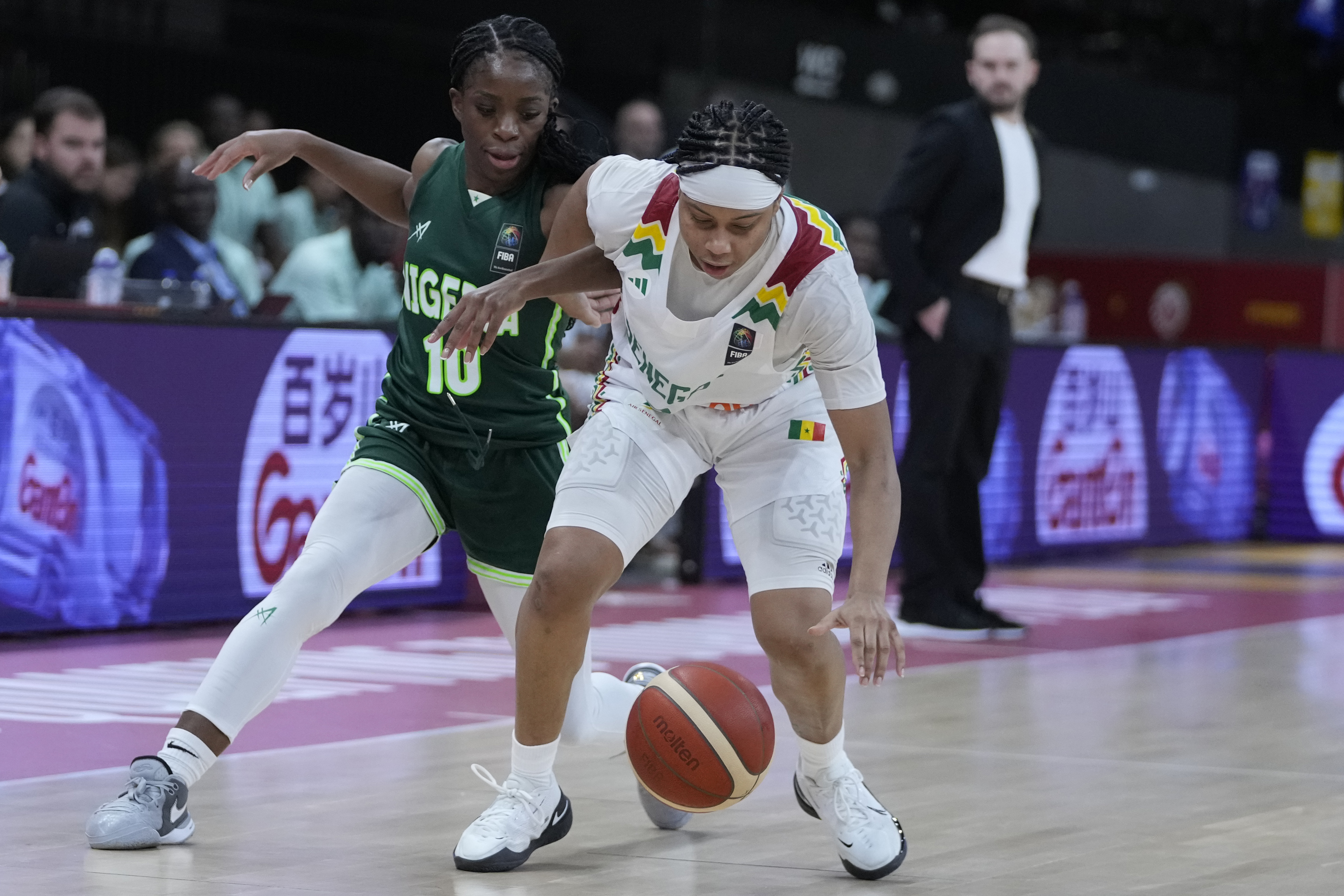 Senegal's Cierra Dillard, right, and Nigeria's Promise Amukamara chase a loose ball during a Women's Olympic Qualifying group A basketball match