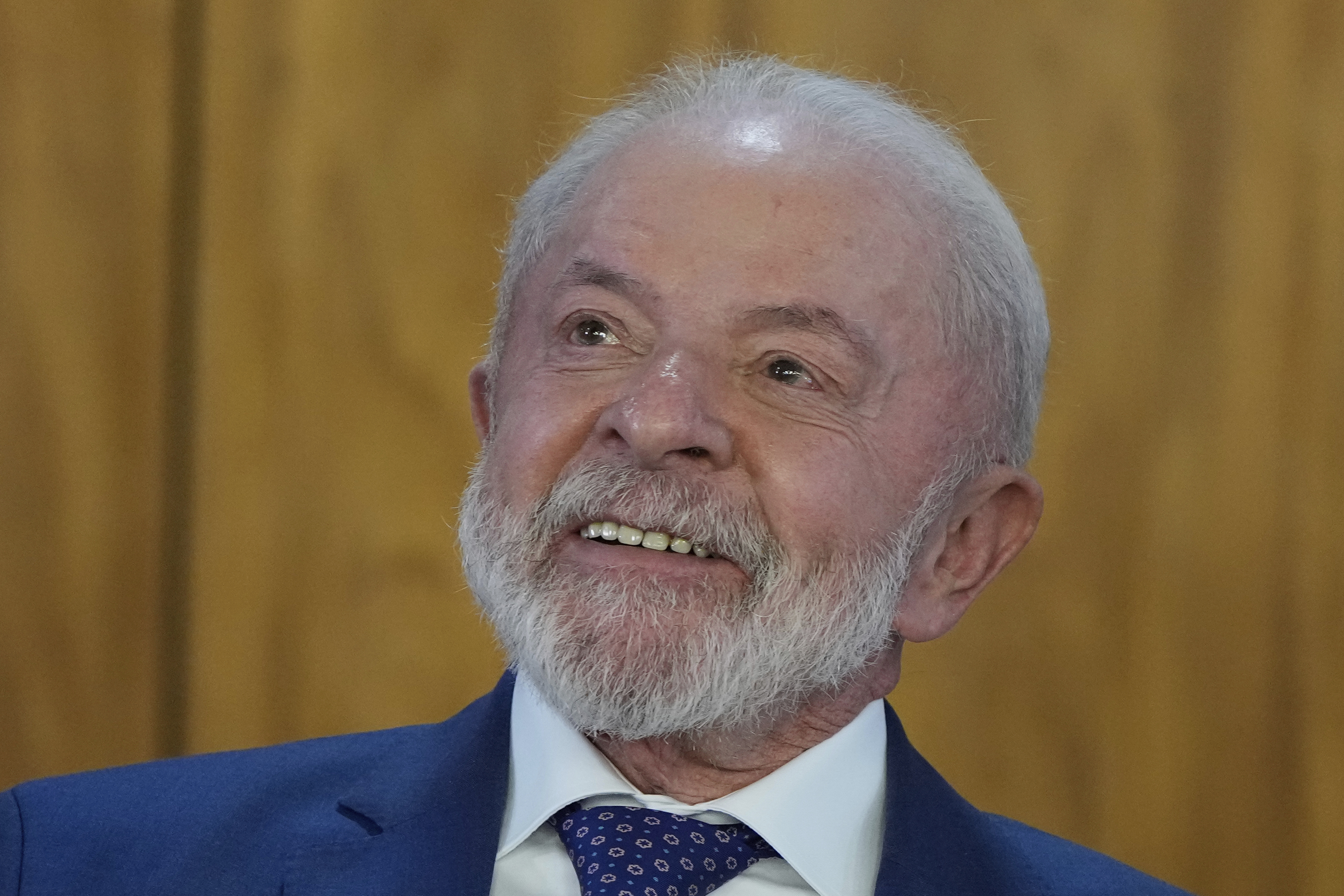 Brazil's President Luiz Inacio Lula da Silva smiles during a signing ceremony to enact the Sovereign Brazil Plan, an aid program to support companies affected by the 50% tariffs imposed on Brazilian products in the United States, at the Planalto presidential palace in Brasilia, Brazil, Wednesday, Aug. 13, 2025. (AP Photo/Eraldo Peres)