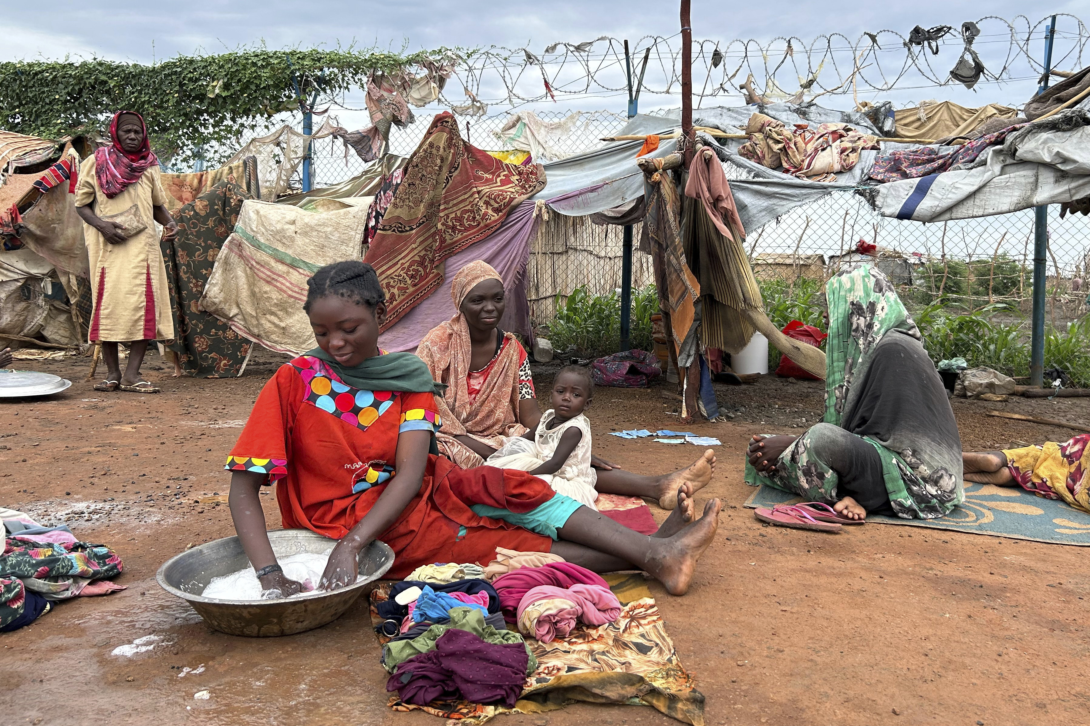 Women do laundry at the Renk transit center, which hosts more than 12,000 people fleeing the war in Sudan, in Renk