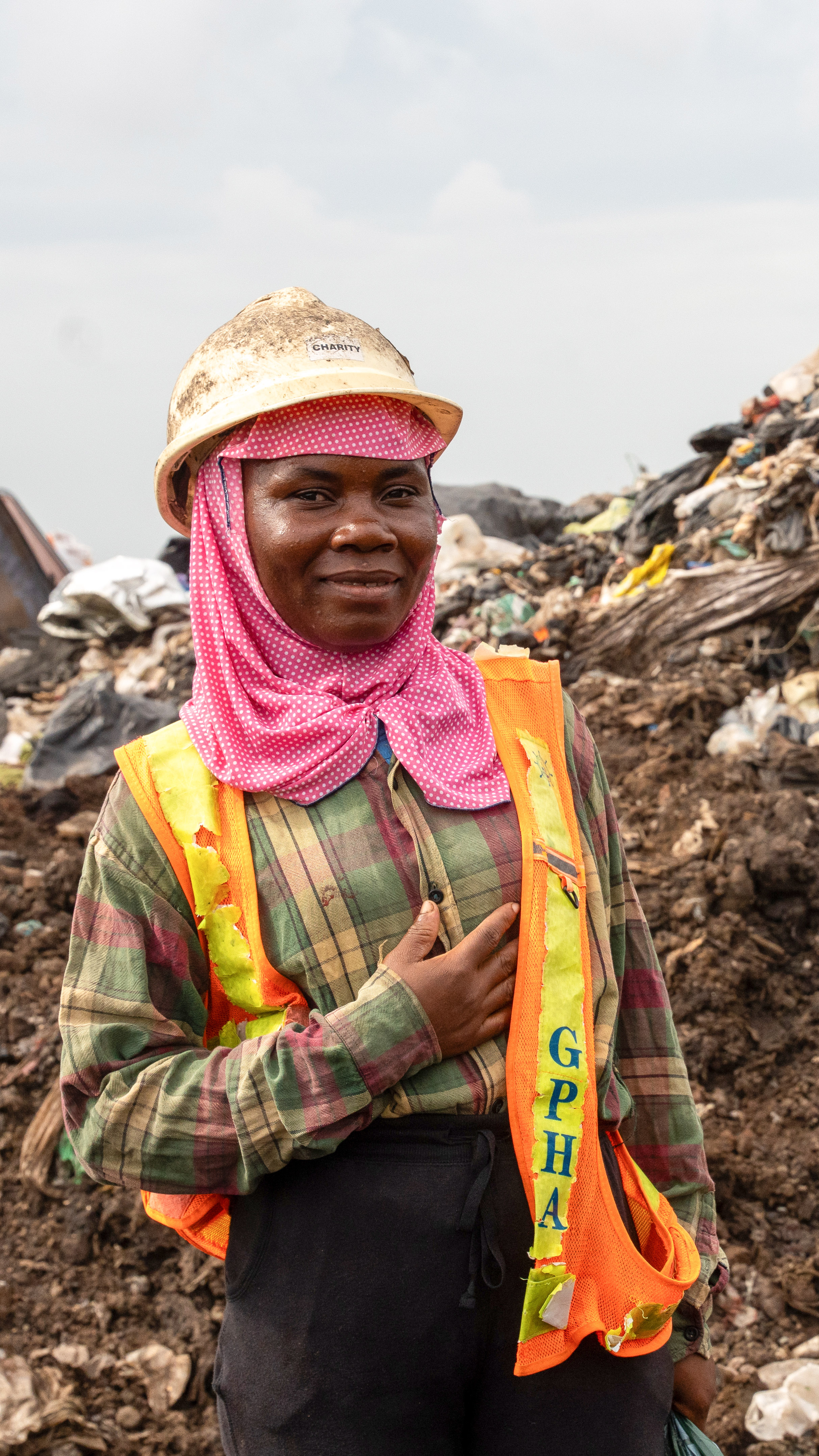 A waste picker in protective gear at a landfill [Costanza Gambarini/SourceMaterial]