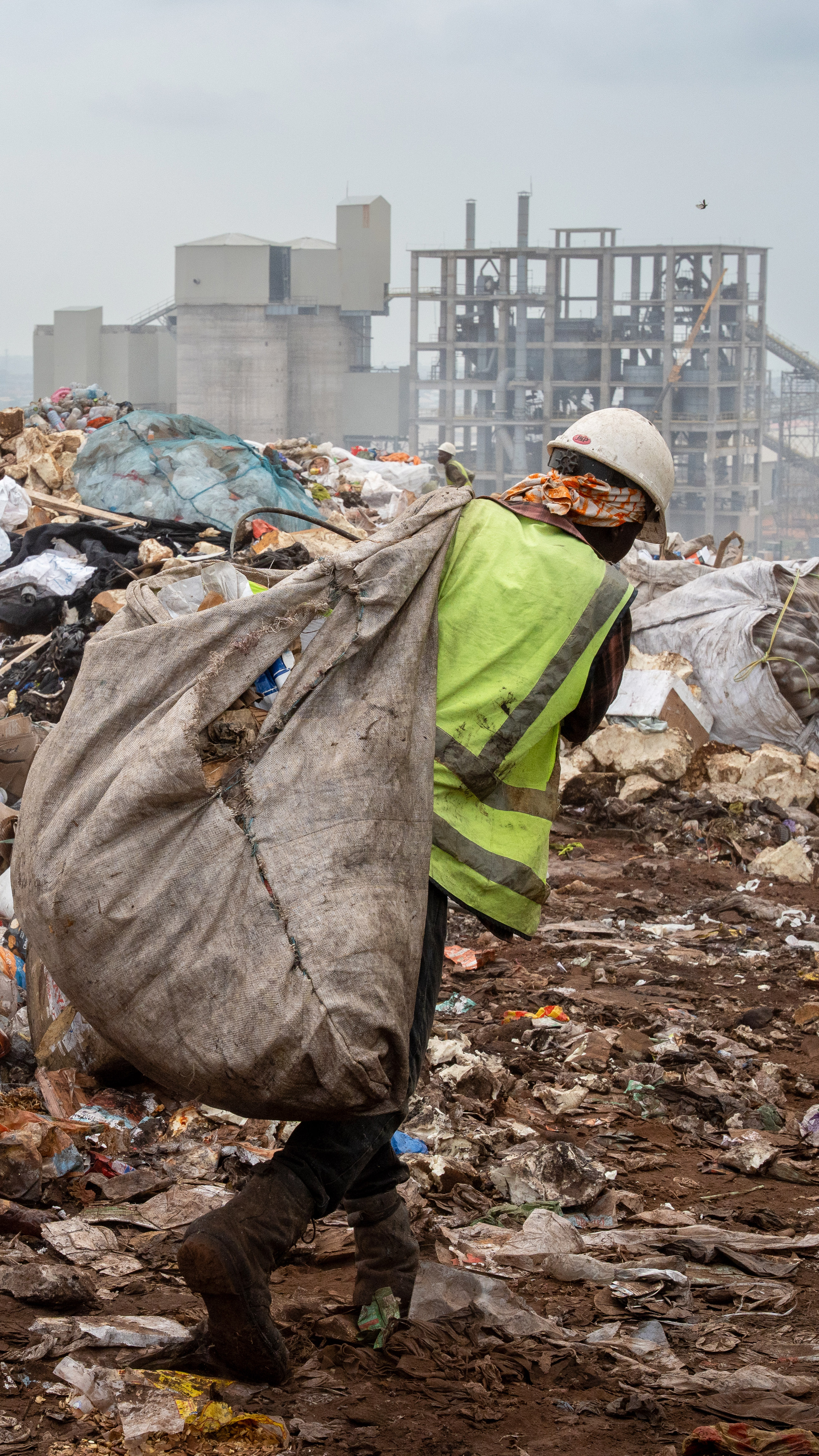 A waste picker moves recyclable waste from the landfill at Tema [Costanza Gambarini/SourceMaterial]