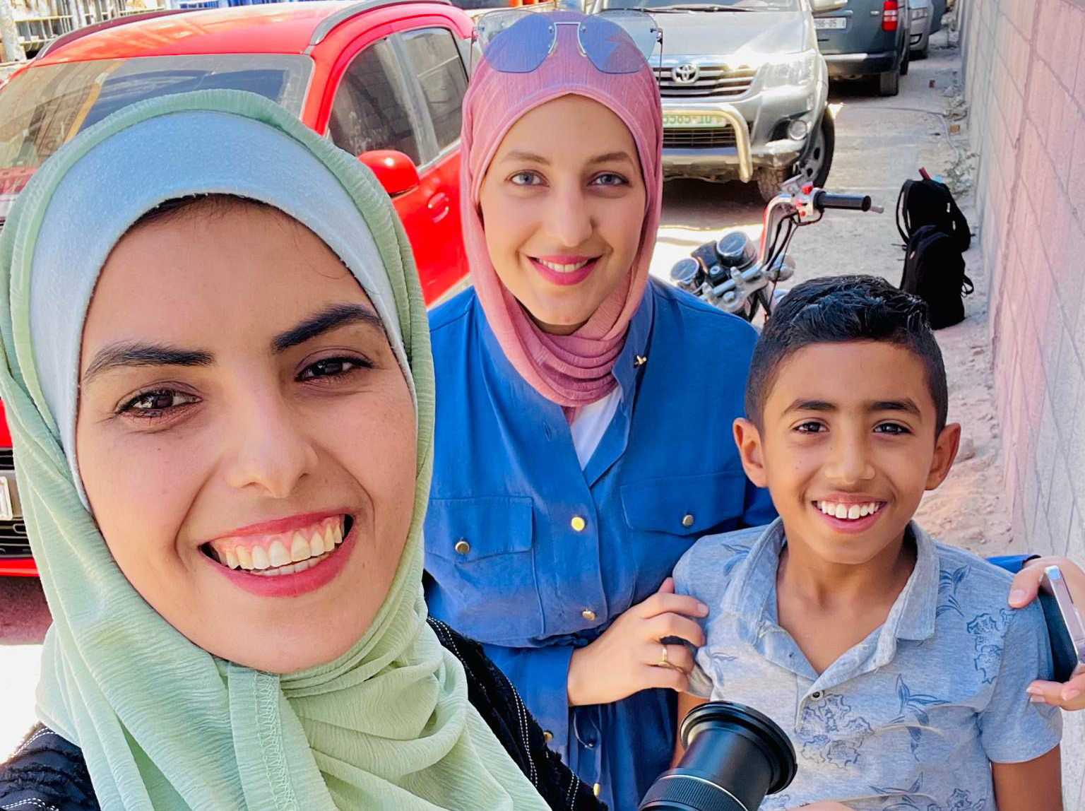 Maryam Abu Daqqa, left, with her son Ghaith, right, and Youmna ElSayed, centre