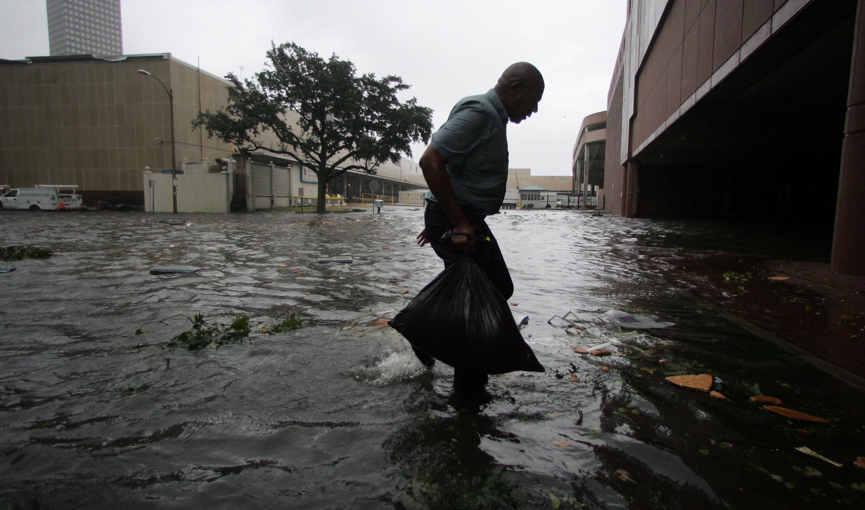 Arnold James carries a small bag of belongings through floodwaters as he tries to make his way on foot to the Louisiana Superdome in New Orleans, Monday, Aug. 29, 2005, after the roof on James's home blew off, forcing him to seek shelter at the Superdome. (AP Photo/Dave Martin)