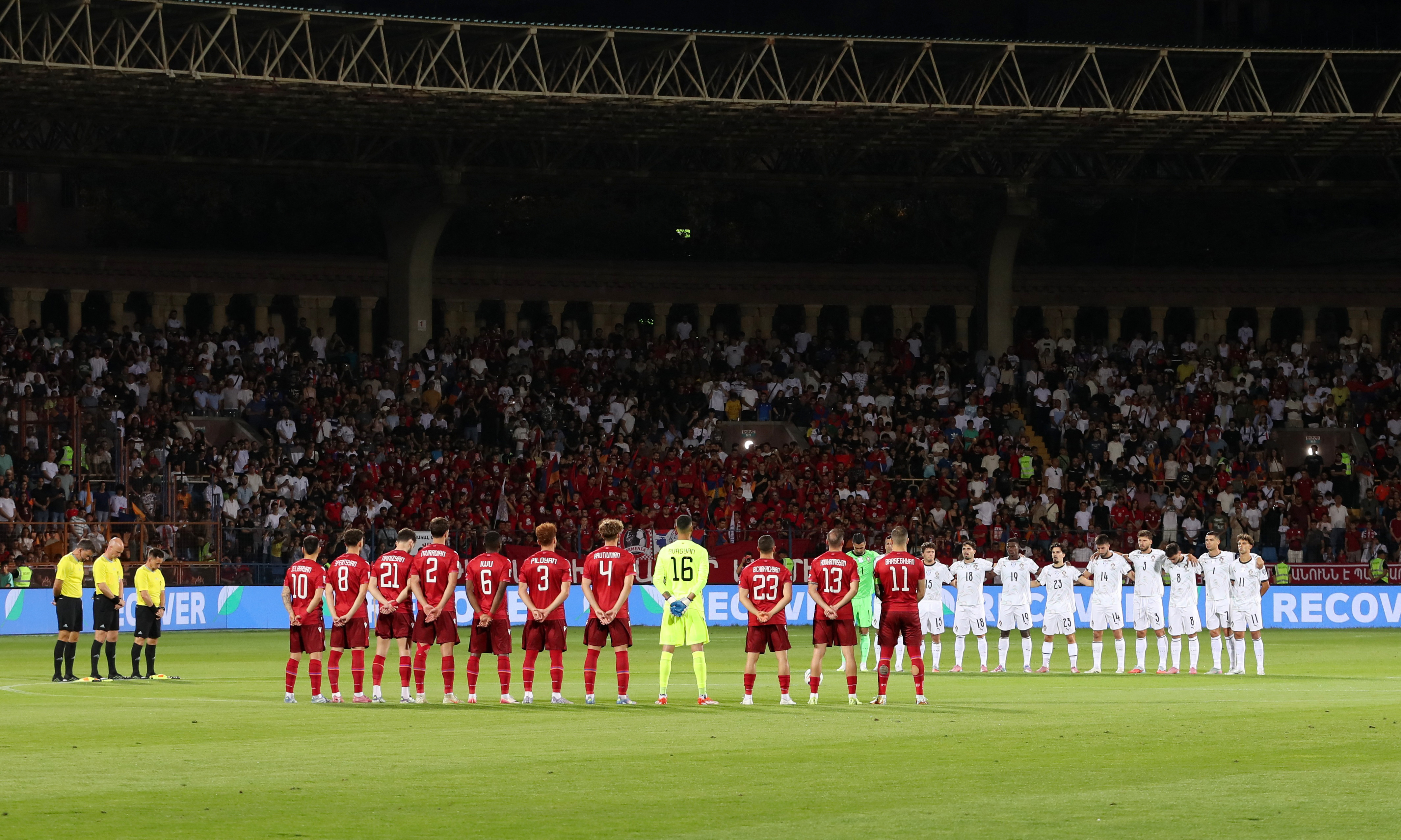 The players and officials stand for a minutes silence in tribute to Liverpool's Diogo Jota and his brother Andre Silva before the match