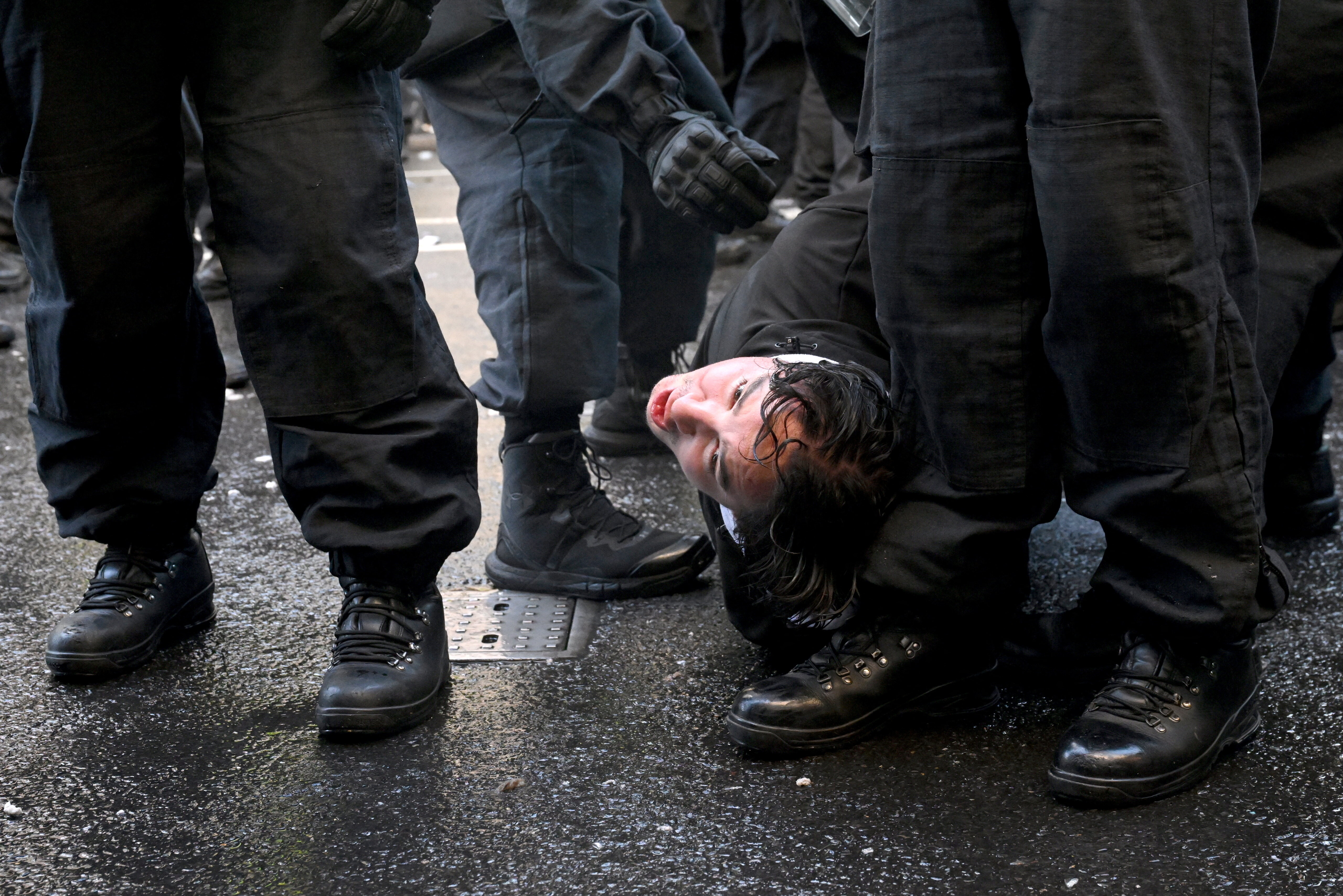 Police officers hold down a supporter of British anti-immigration activist Stephen Yaxley-Lennon, also known as Tommy Robinson, during a demonstration, in London, Britain, September 13,, 2025. REUTERS/Jaimi Joy